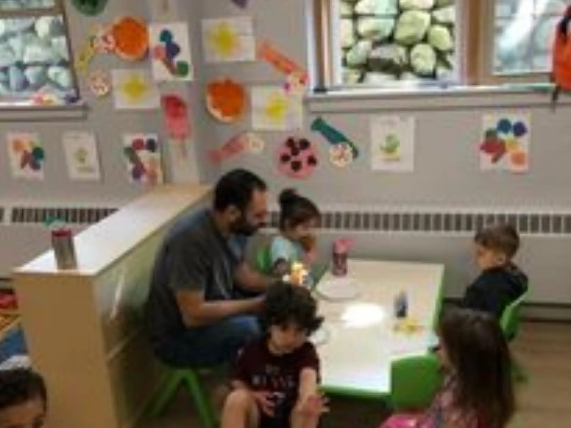 a group of children sitting around a table