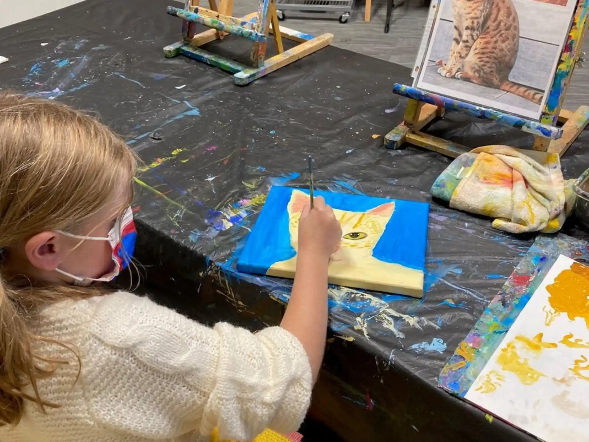 a girl painting on a table