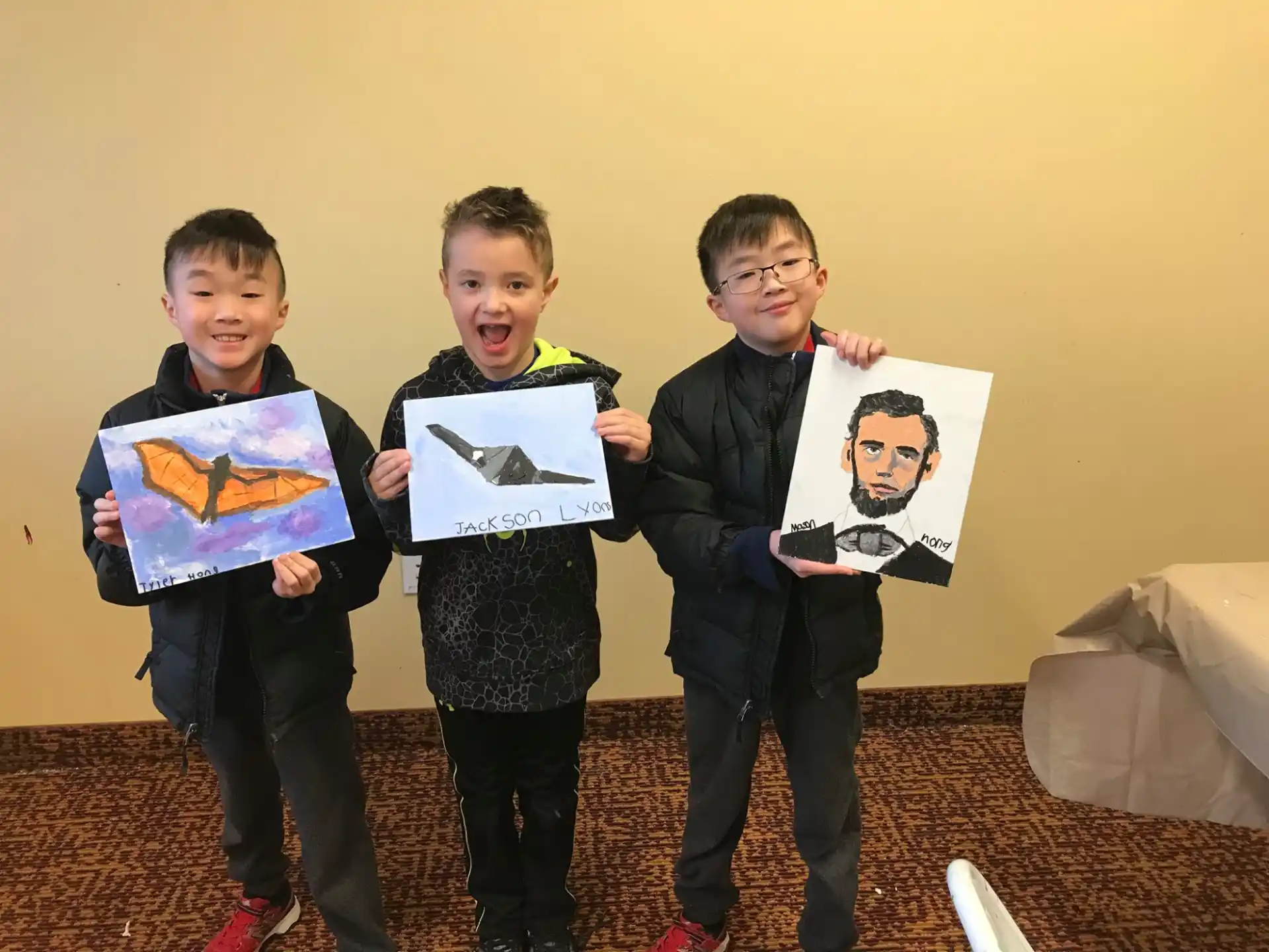a group of boys holding up posters