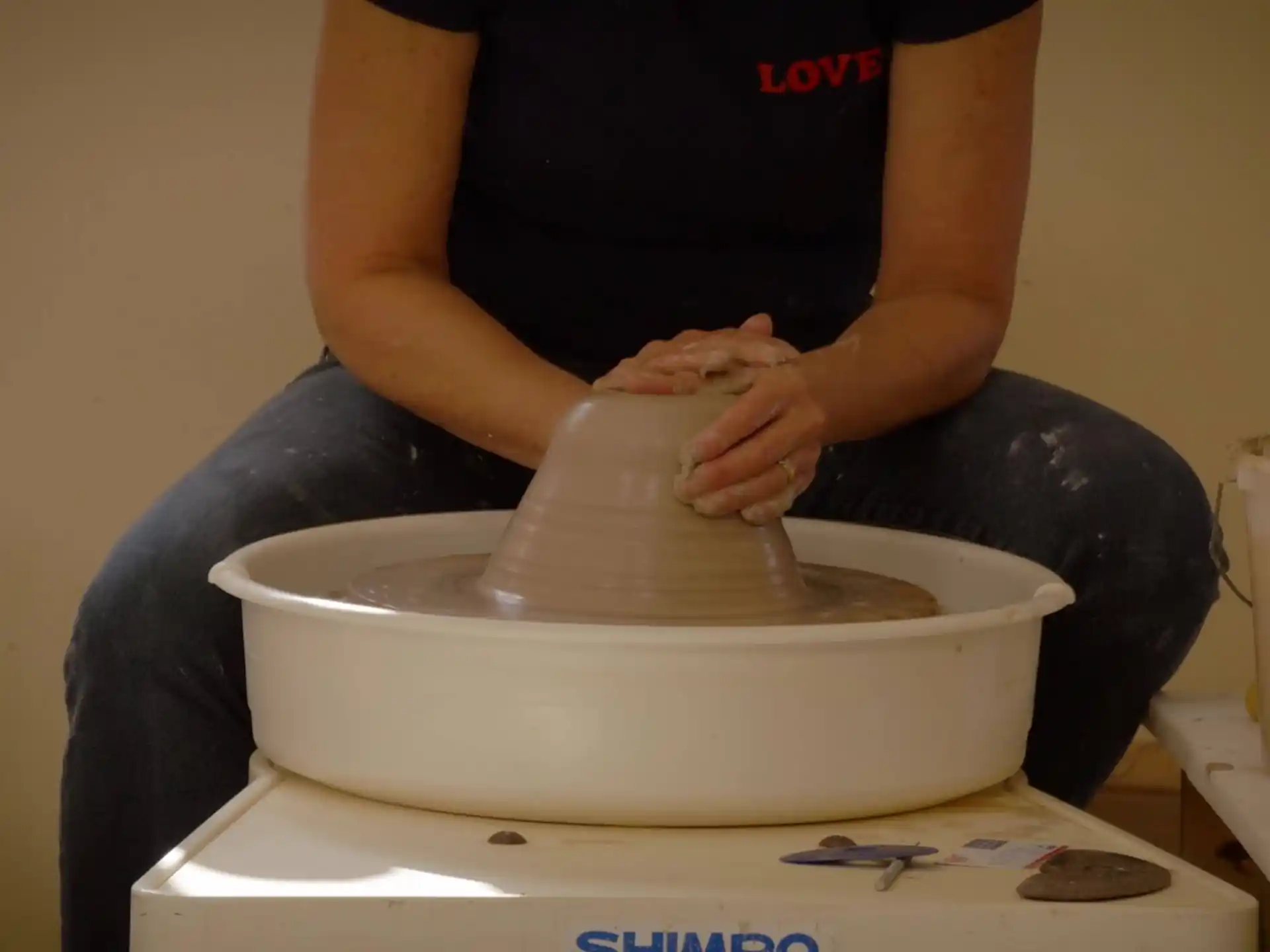 a person mixing a substance in a bowl