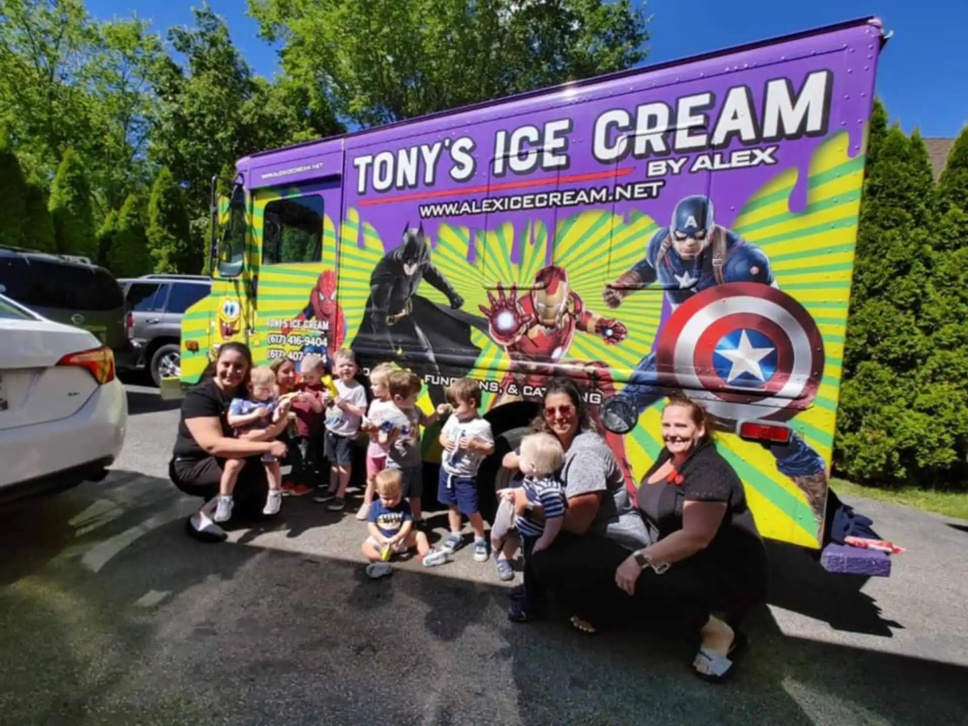 a group of people posing for a photo in front of a bus