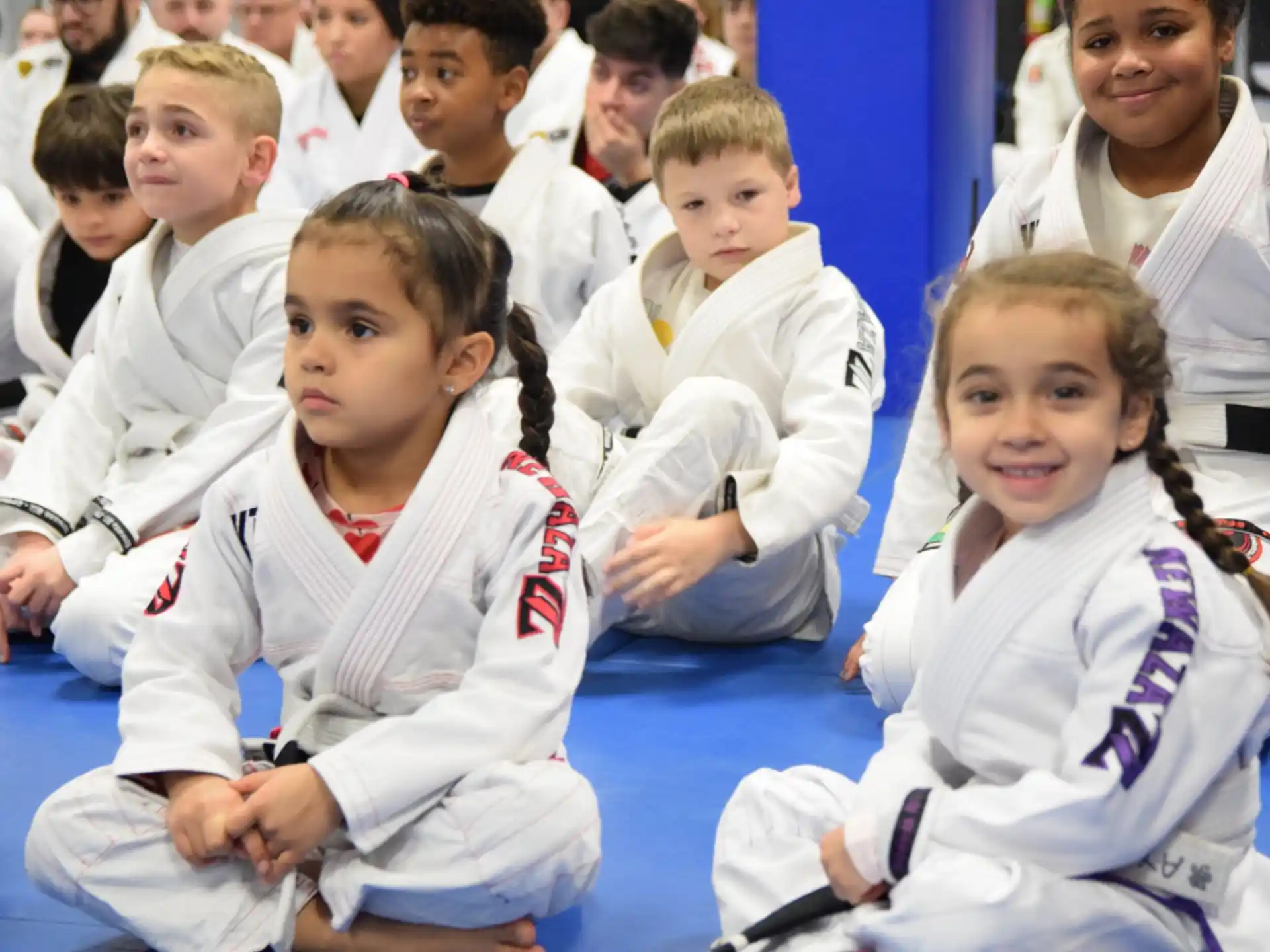 a group of children in white uniforms