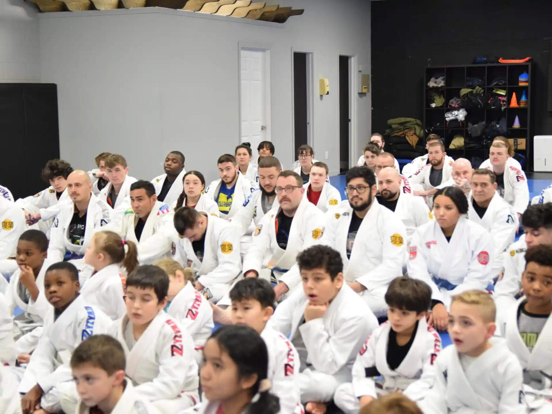 a group of people in white karate uniforms