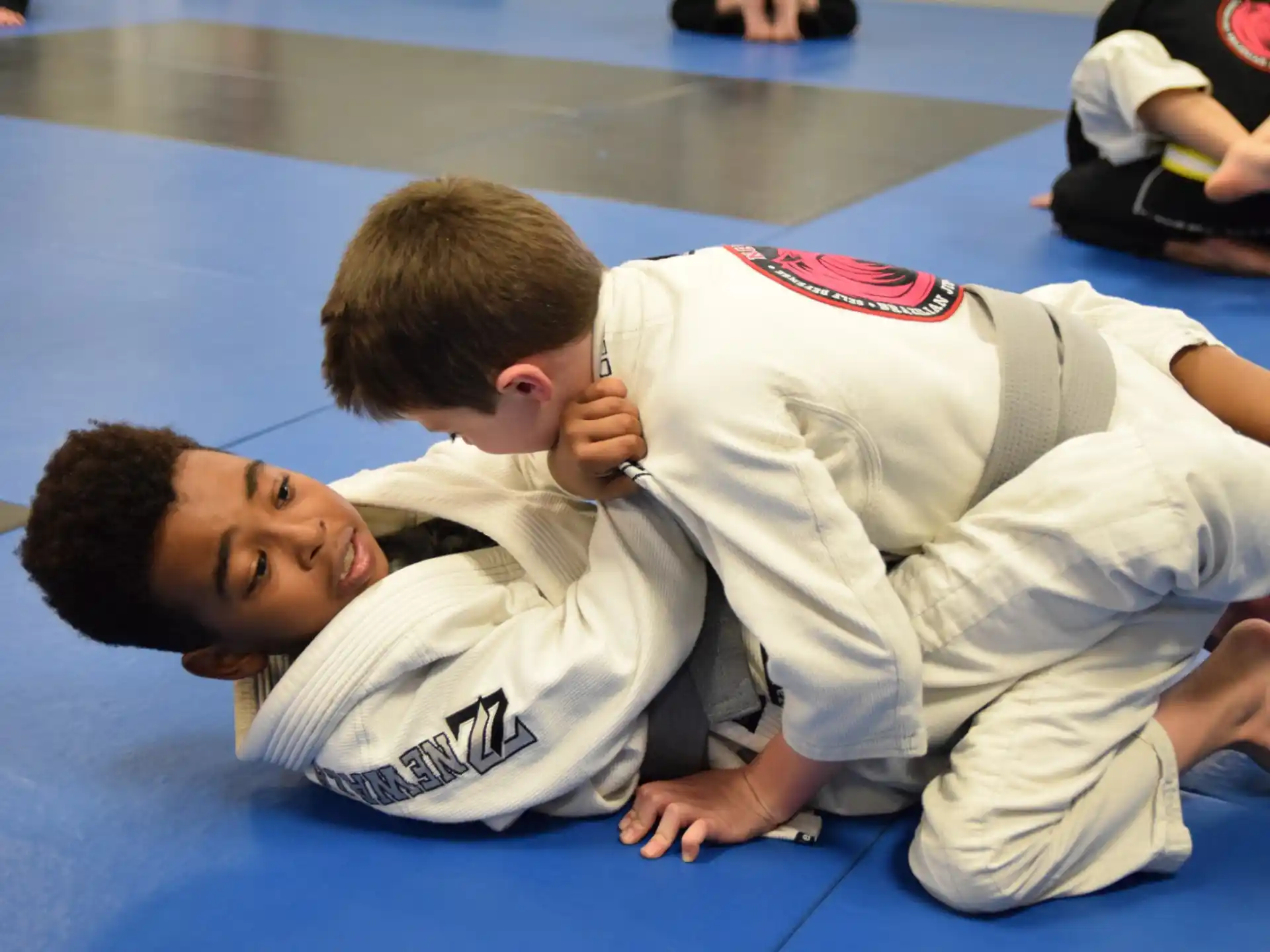a man and a boy in karate uniforms on a mat
