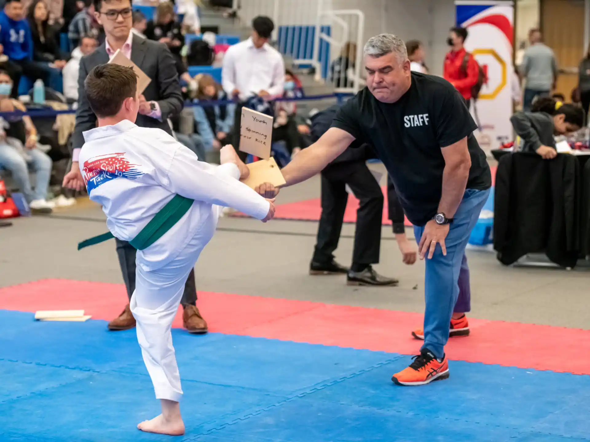 a person in a karate uniform with a person in a black shirt