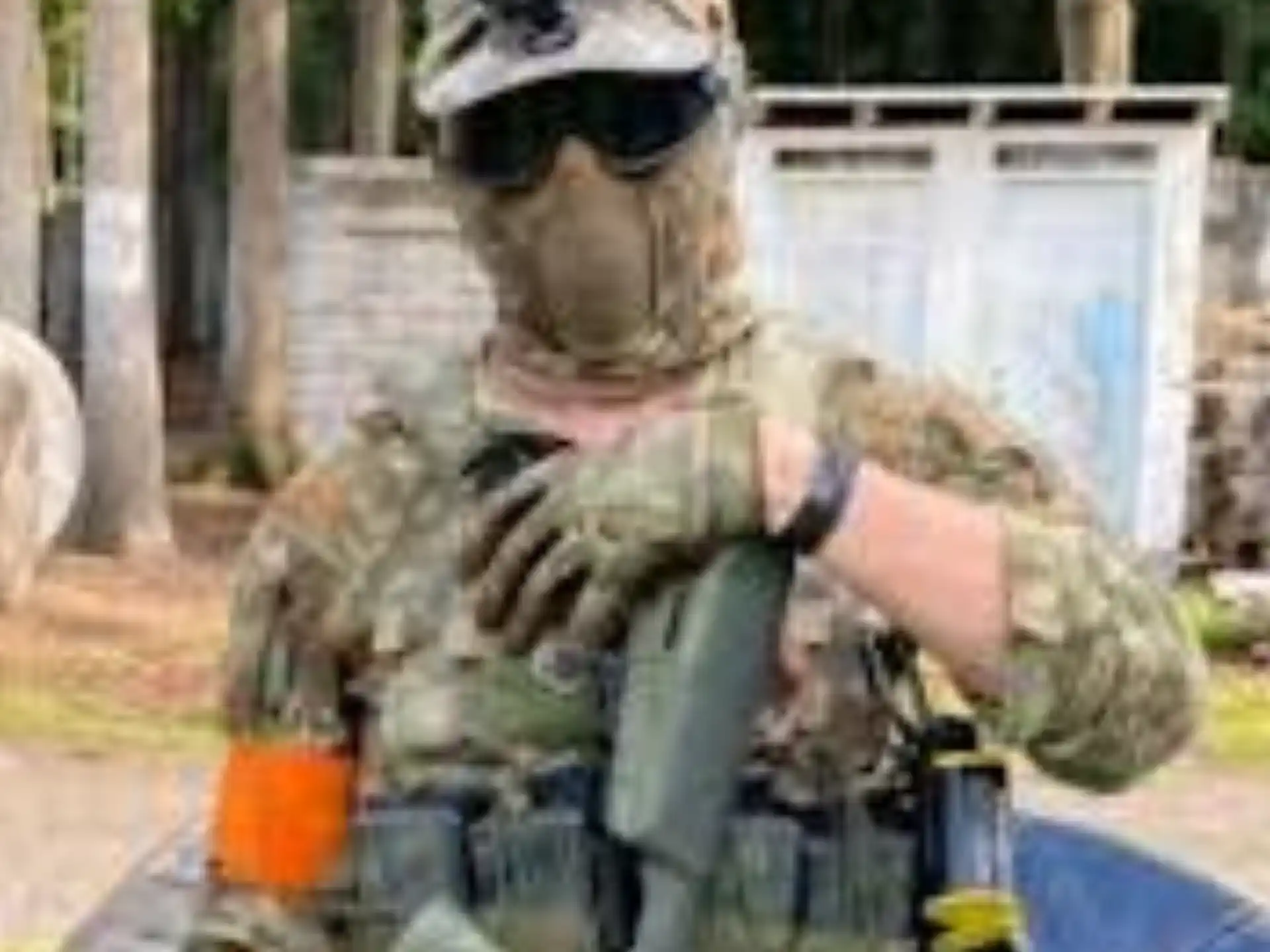a man in a garment holding a gun
