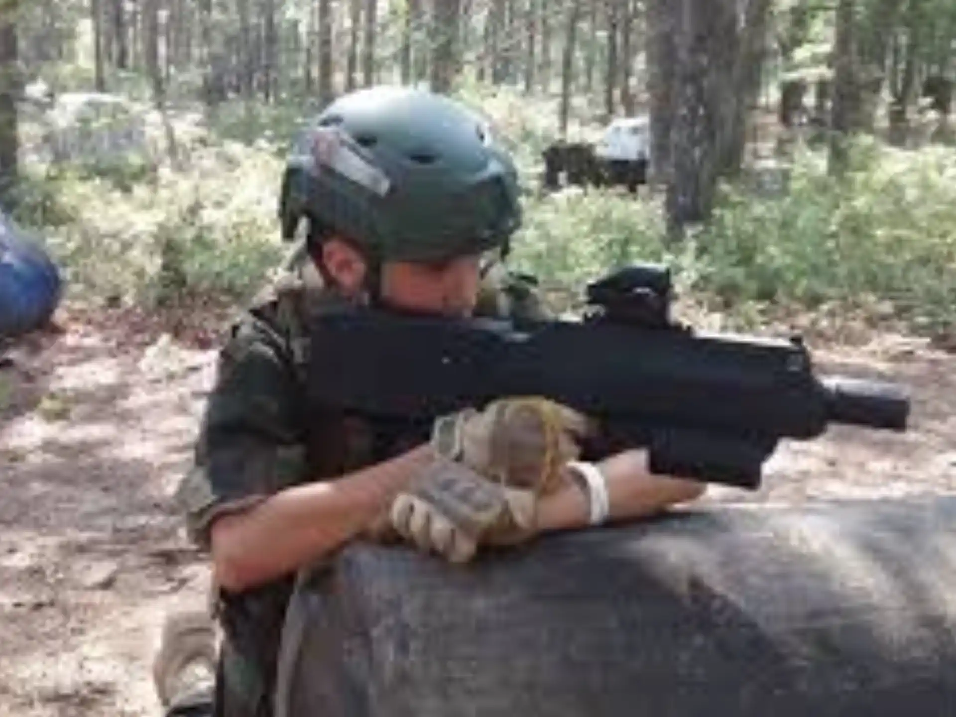 a man in a helmet holding a gun
