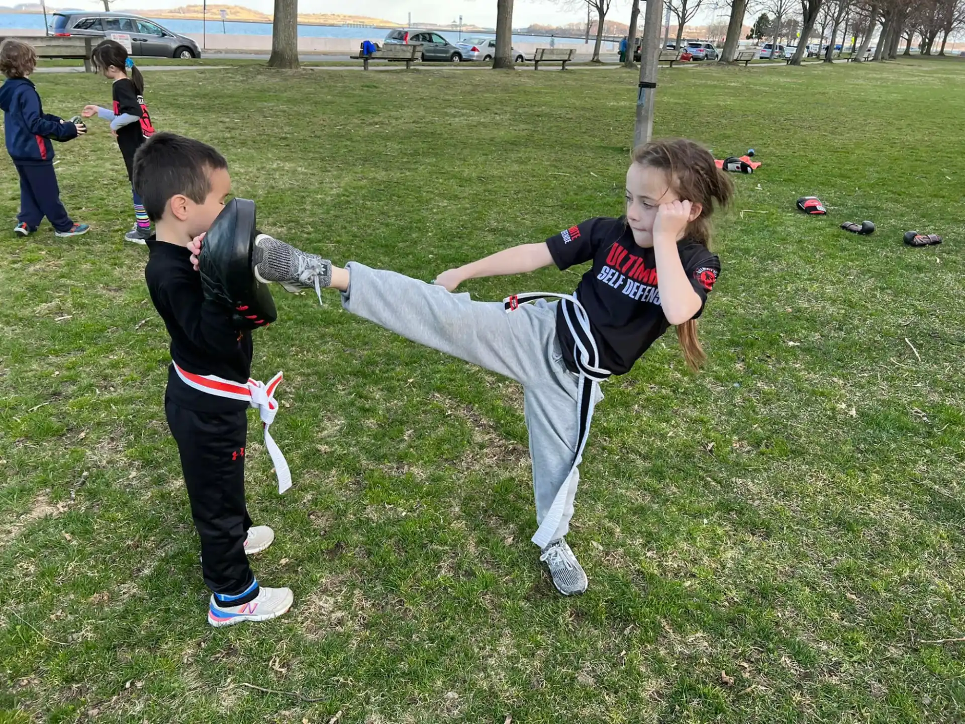 a person and a boy playing in a grassy field