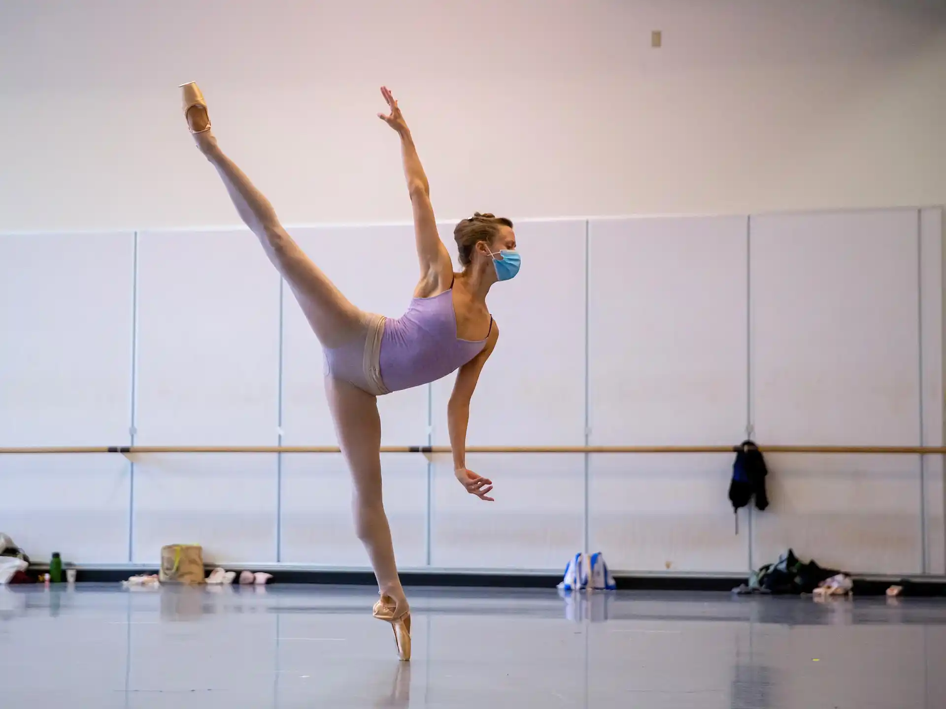 a woman in a leotard doing a handstand on a stage
