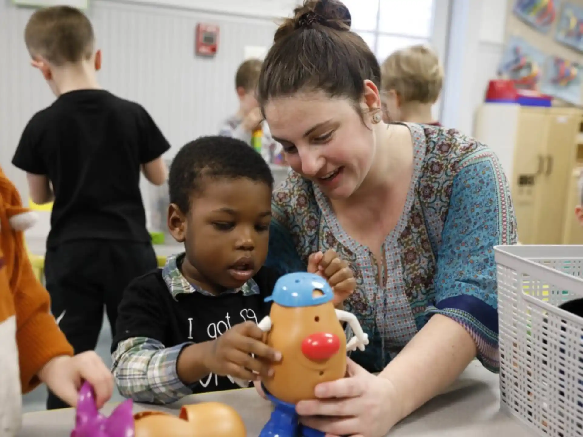 a person and a child playing with a toy