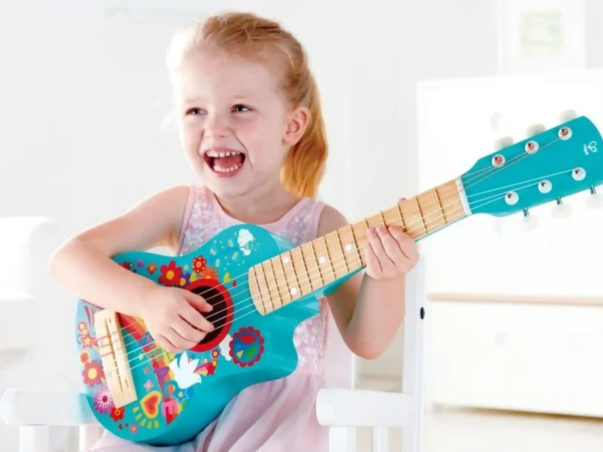 a child holding a guitar