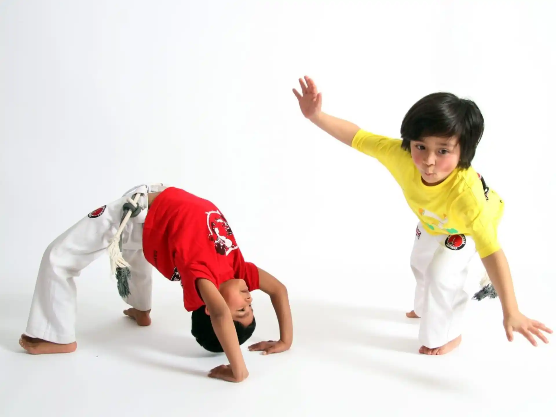 a couple of kids in karate uniforms