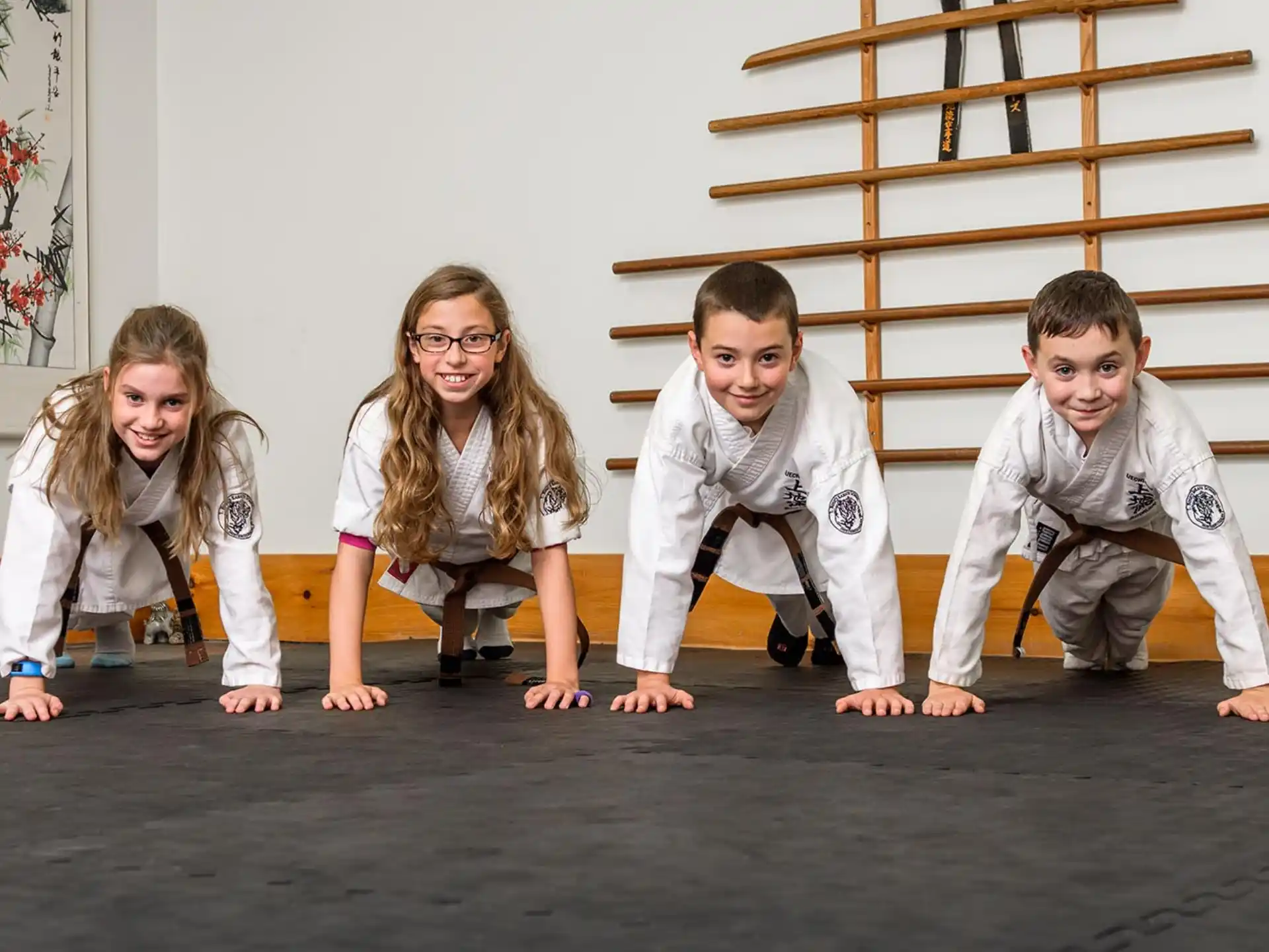 a group of children in karate uniforms