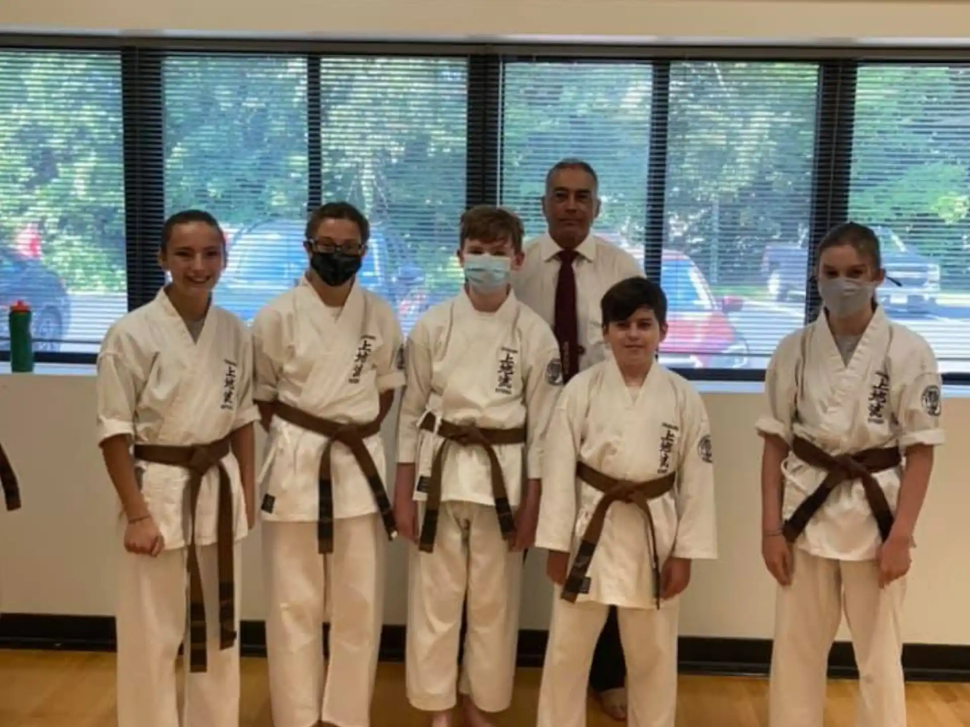 a group of people in karate uniforms