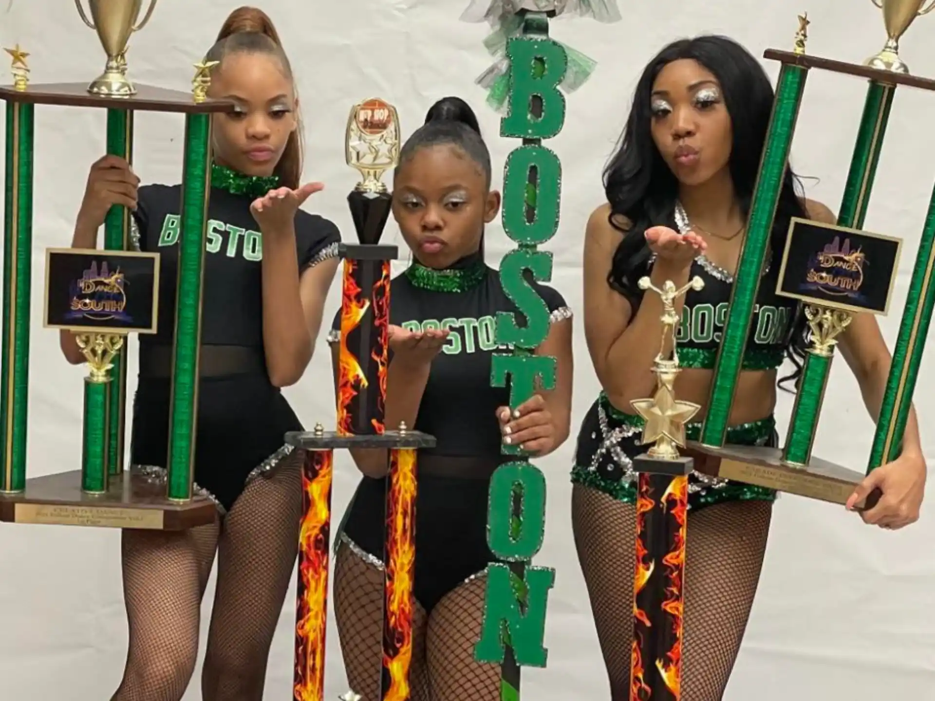 a group of women holding trophies