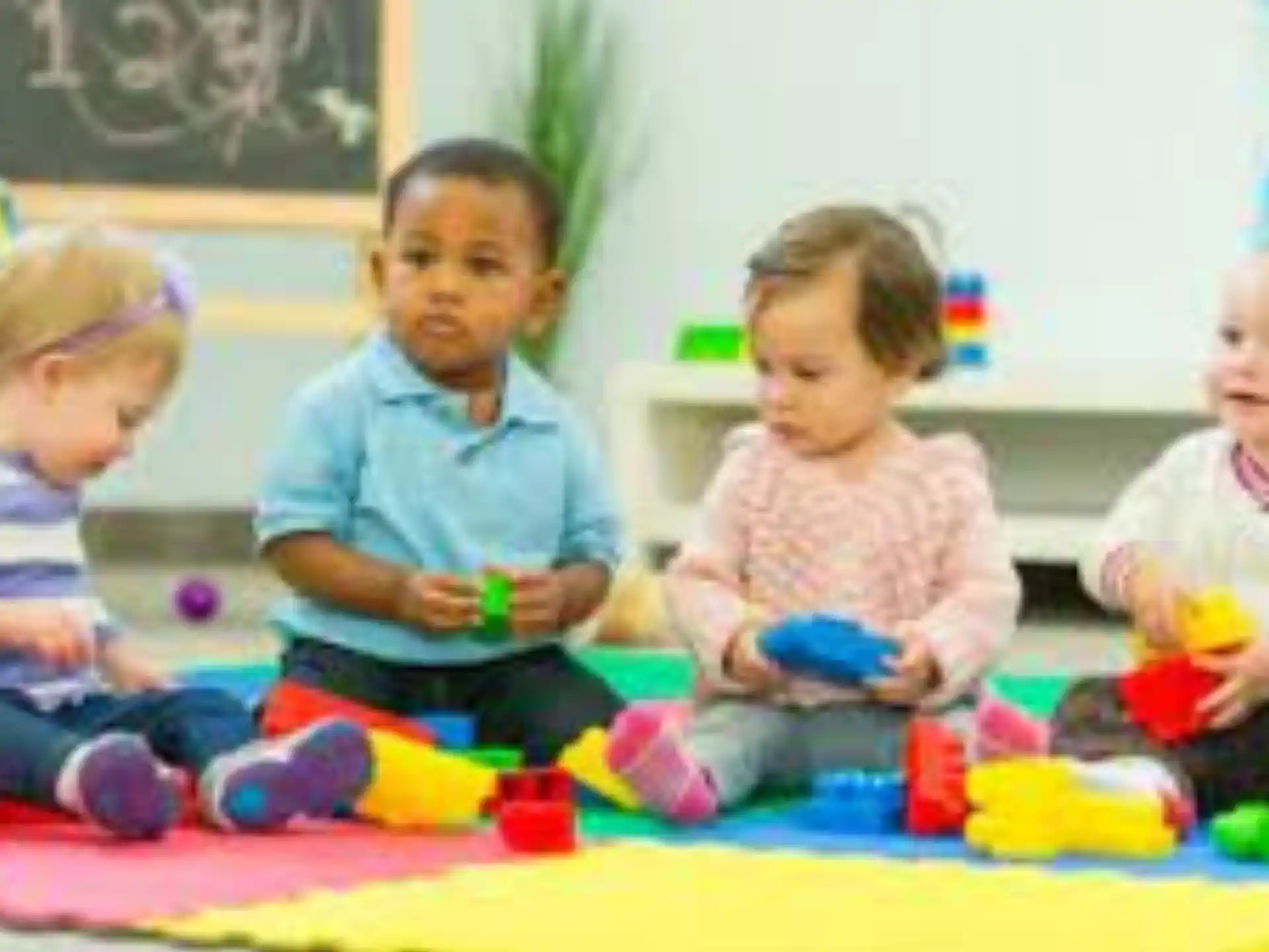 a group of children sitting on the floor playing with toys