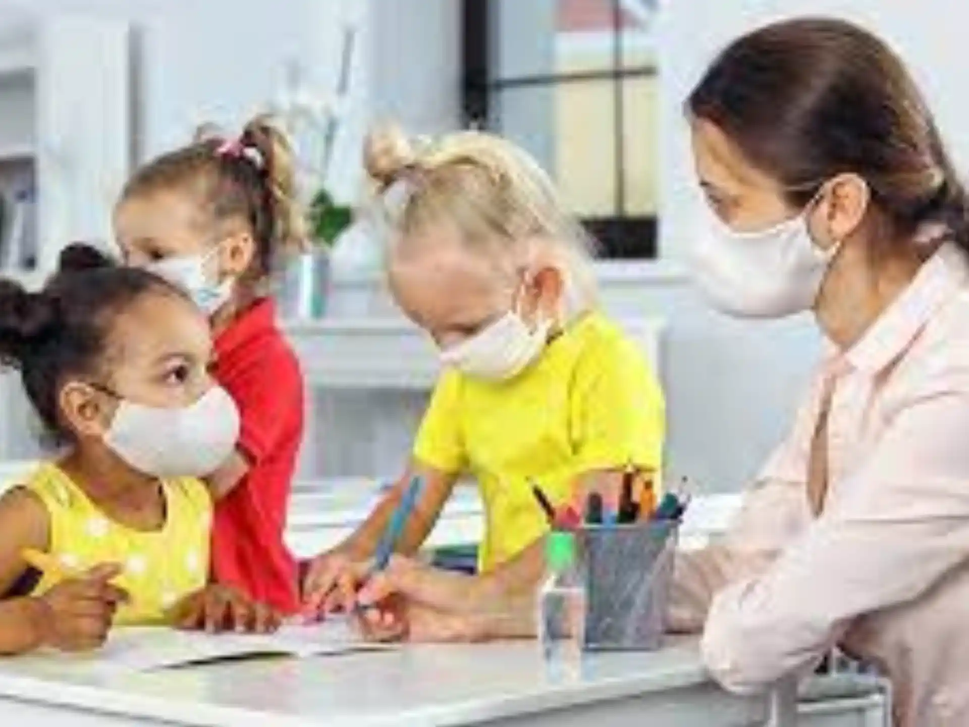 a person and several children wearing masks