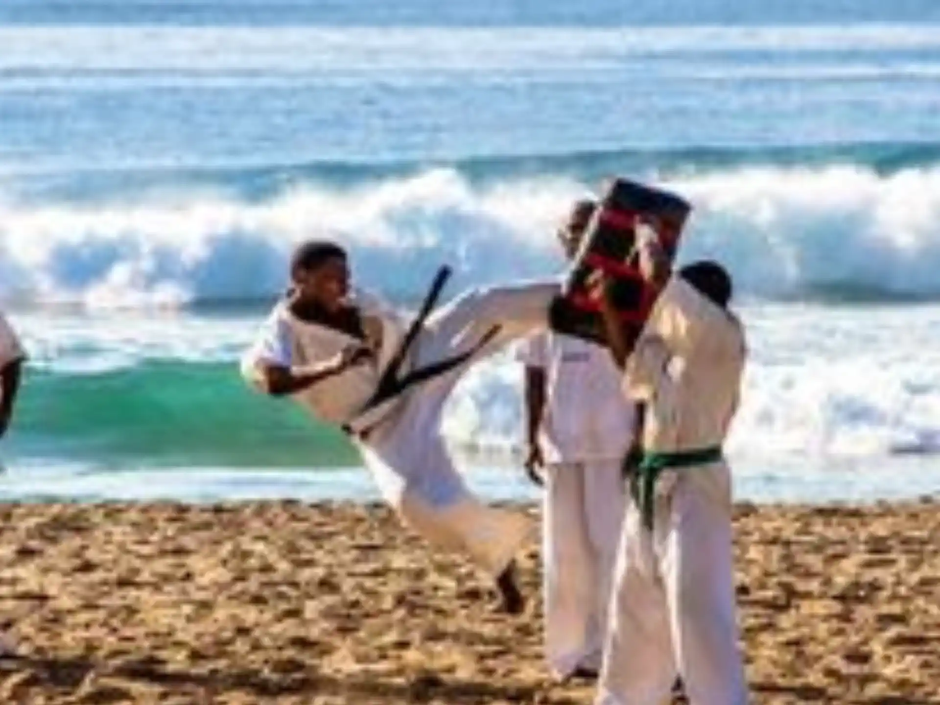 a group of men in white robes holding a white bird on a beach
