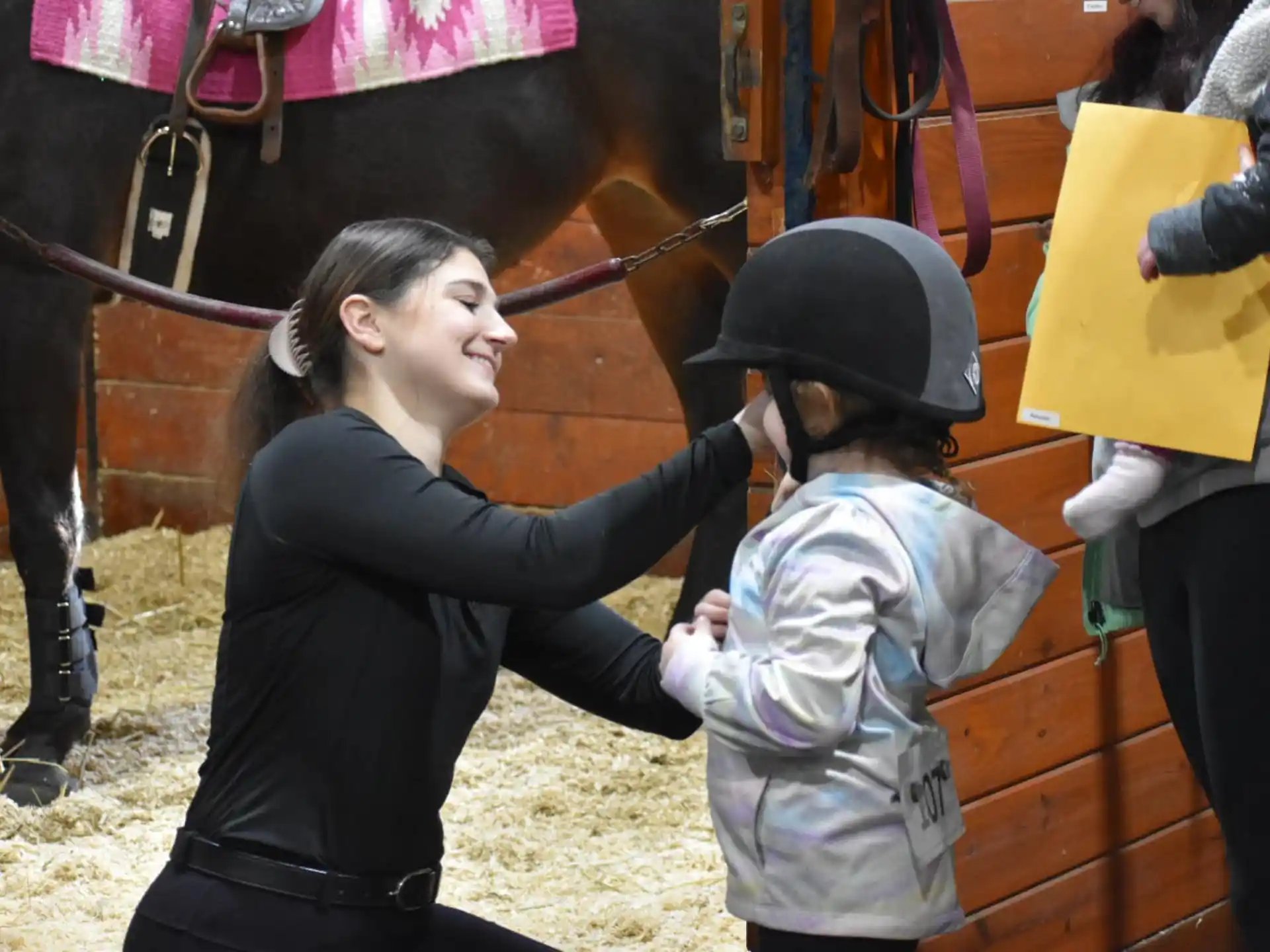 a person and a child petting a horse