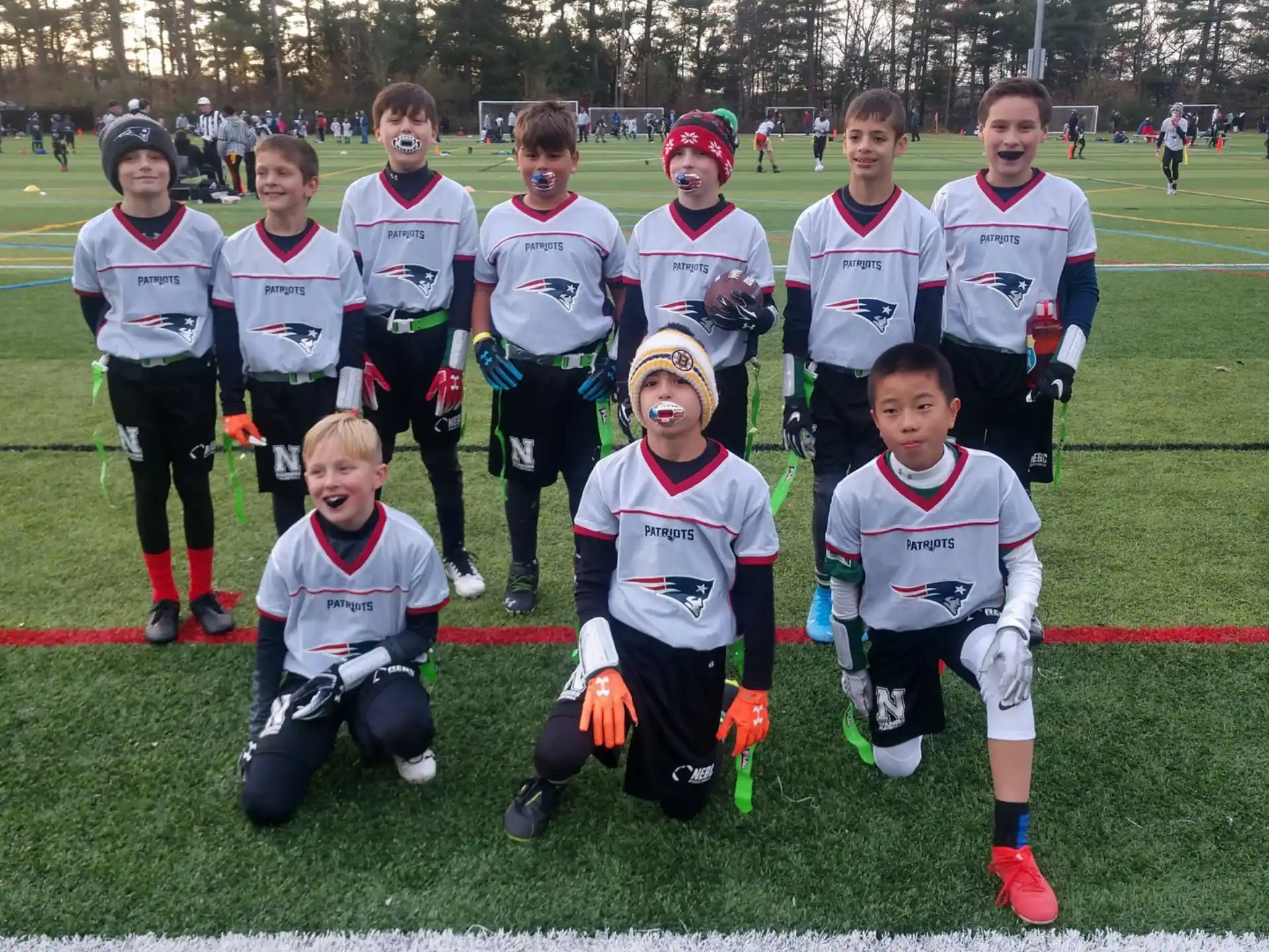 a group of kids posing for a picture on a field