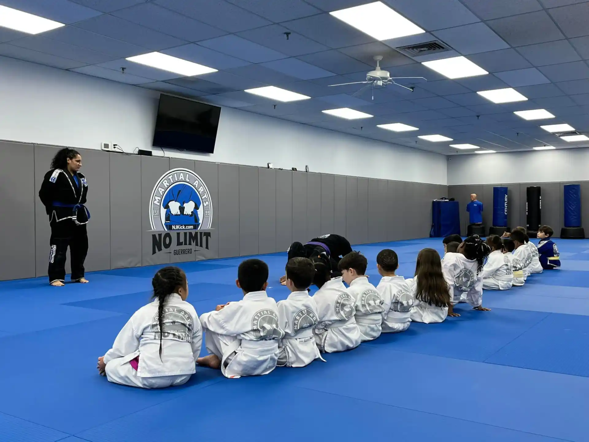 a person standing in front of a group of people sitting in a room