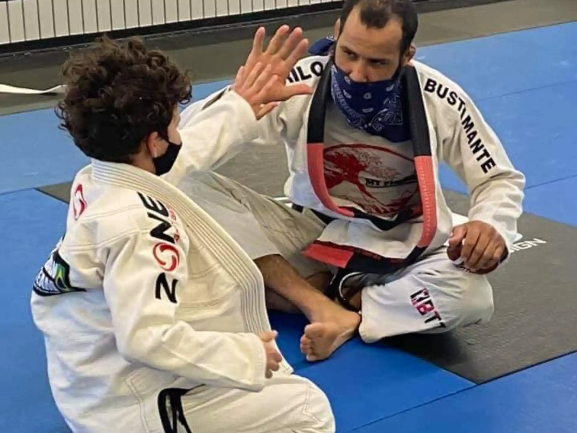 a couple of men in karate uniforms