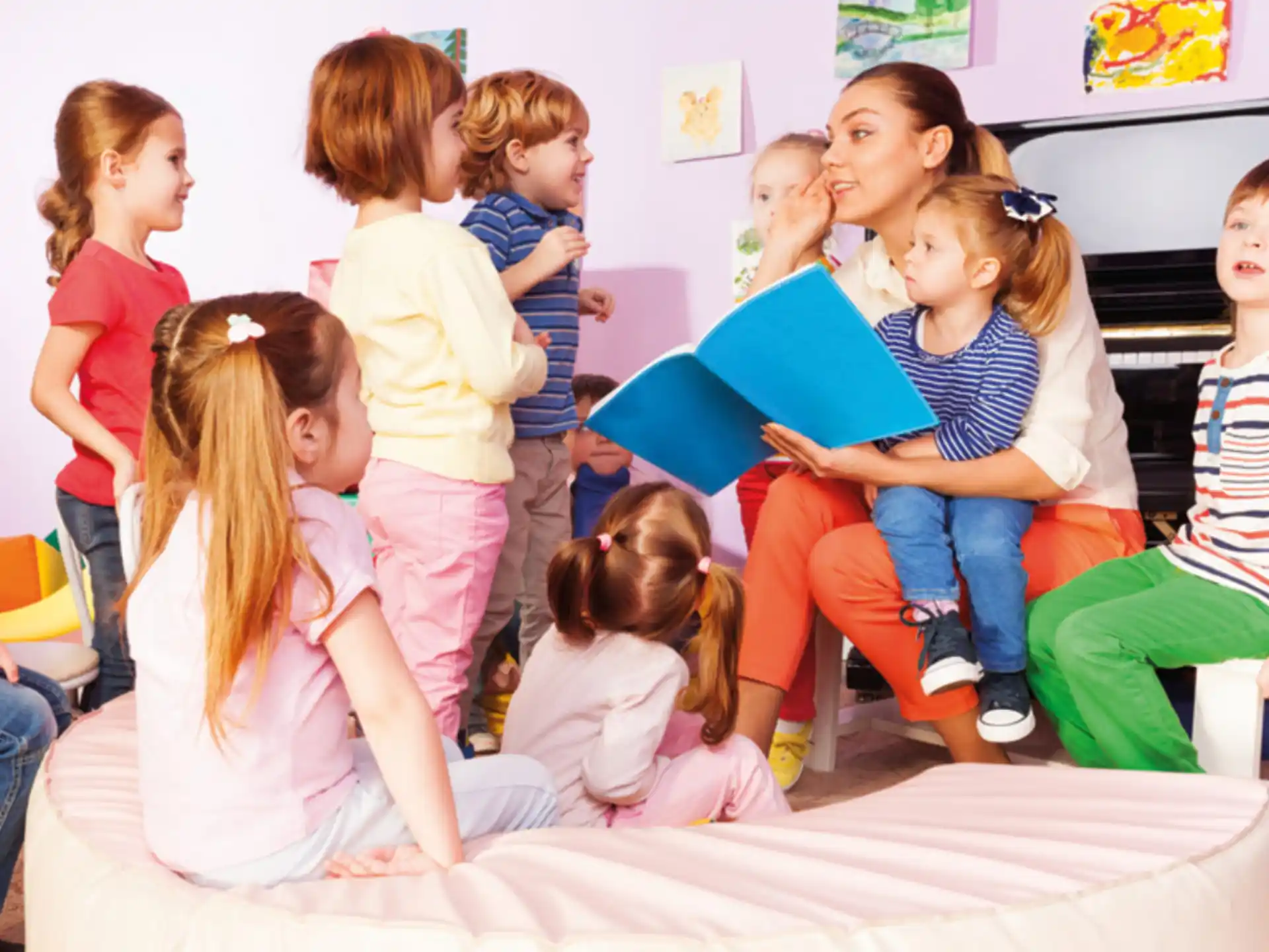 a group of children sitting on a bed