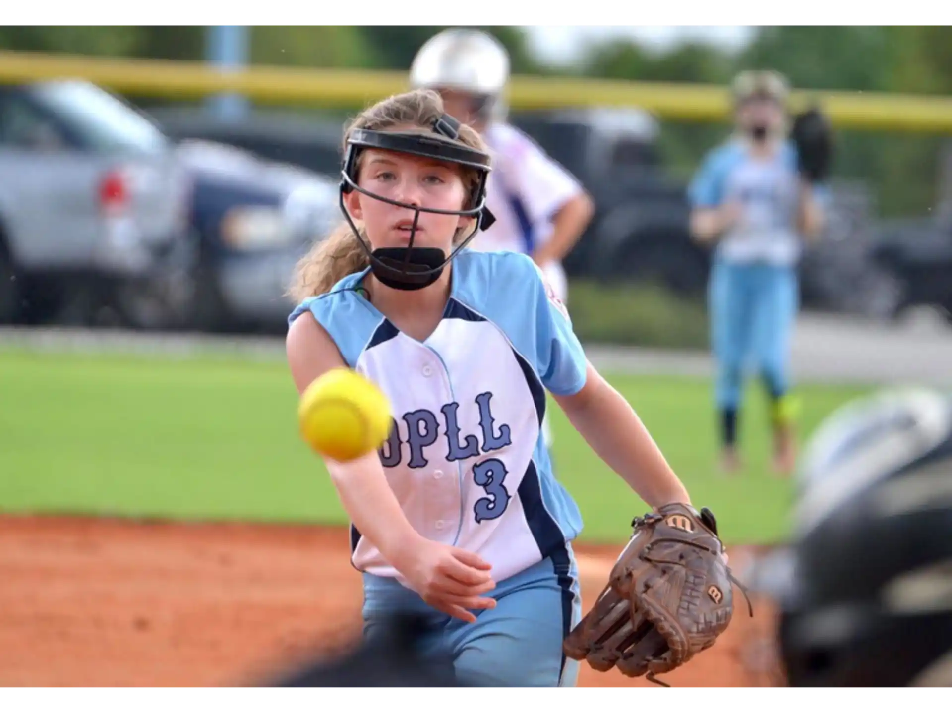 a girl catching a baseball