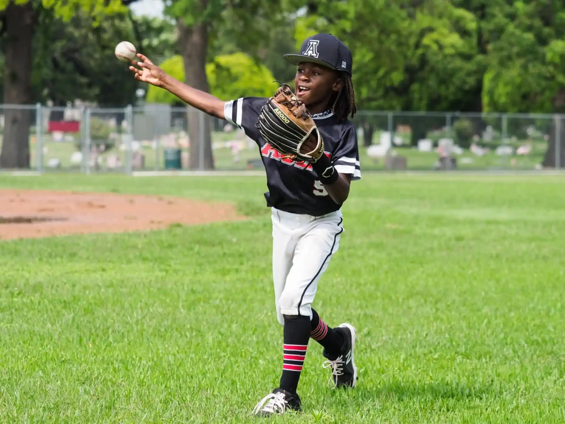 a young boy throwing a baseball