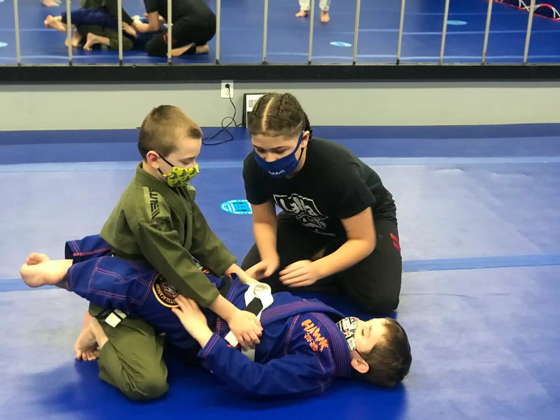 a person helping a boy with a medal