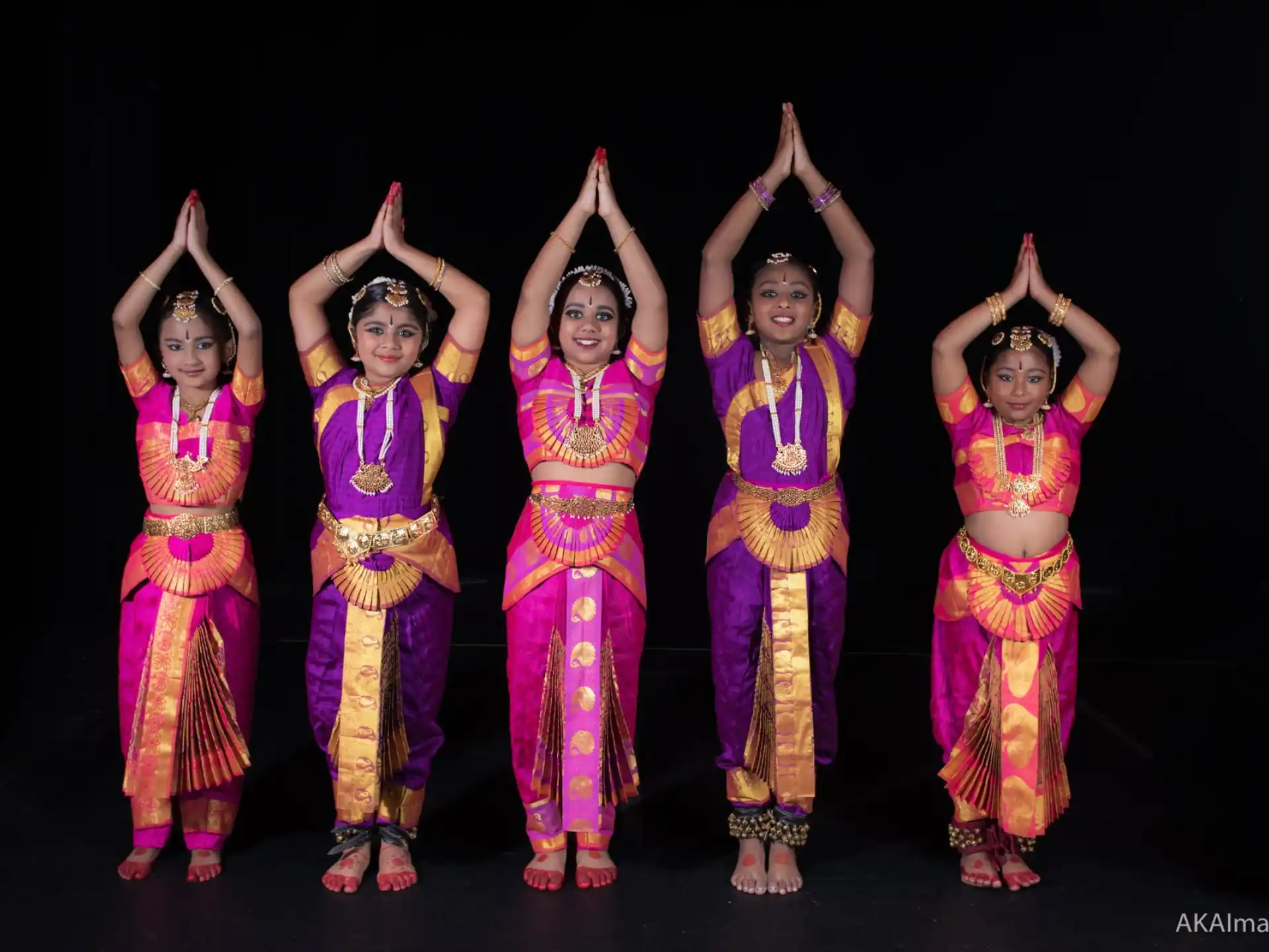 a group of women in colorful dresses
