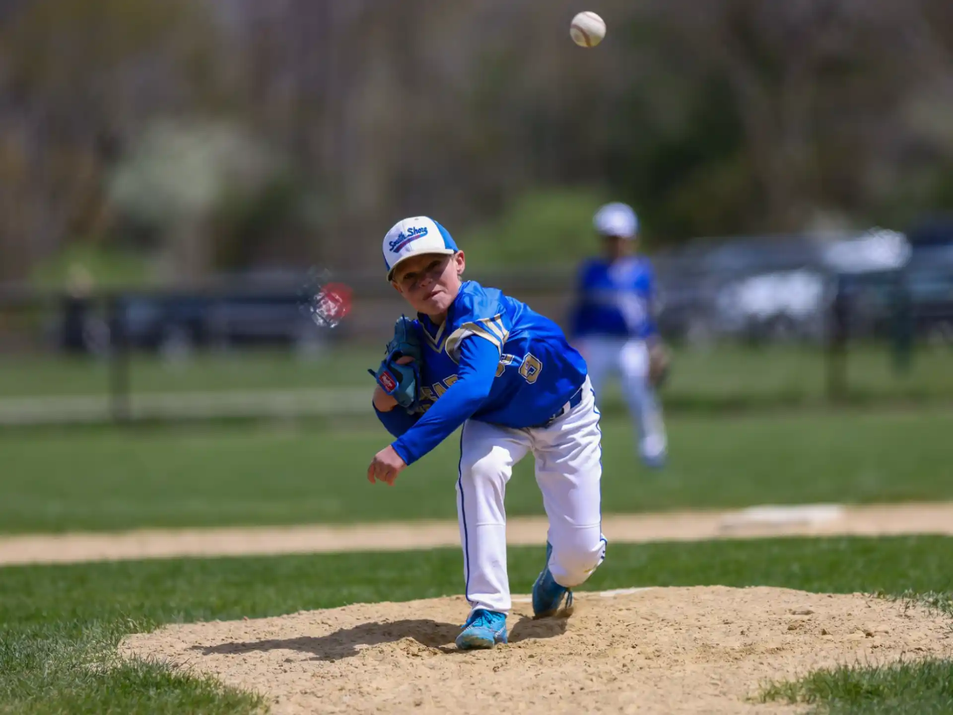 a kid throwing a baseball