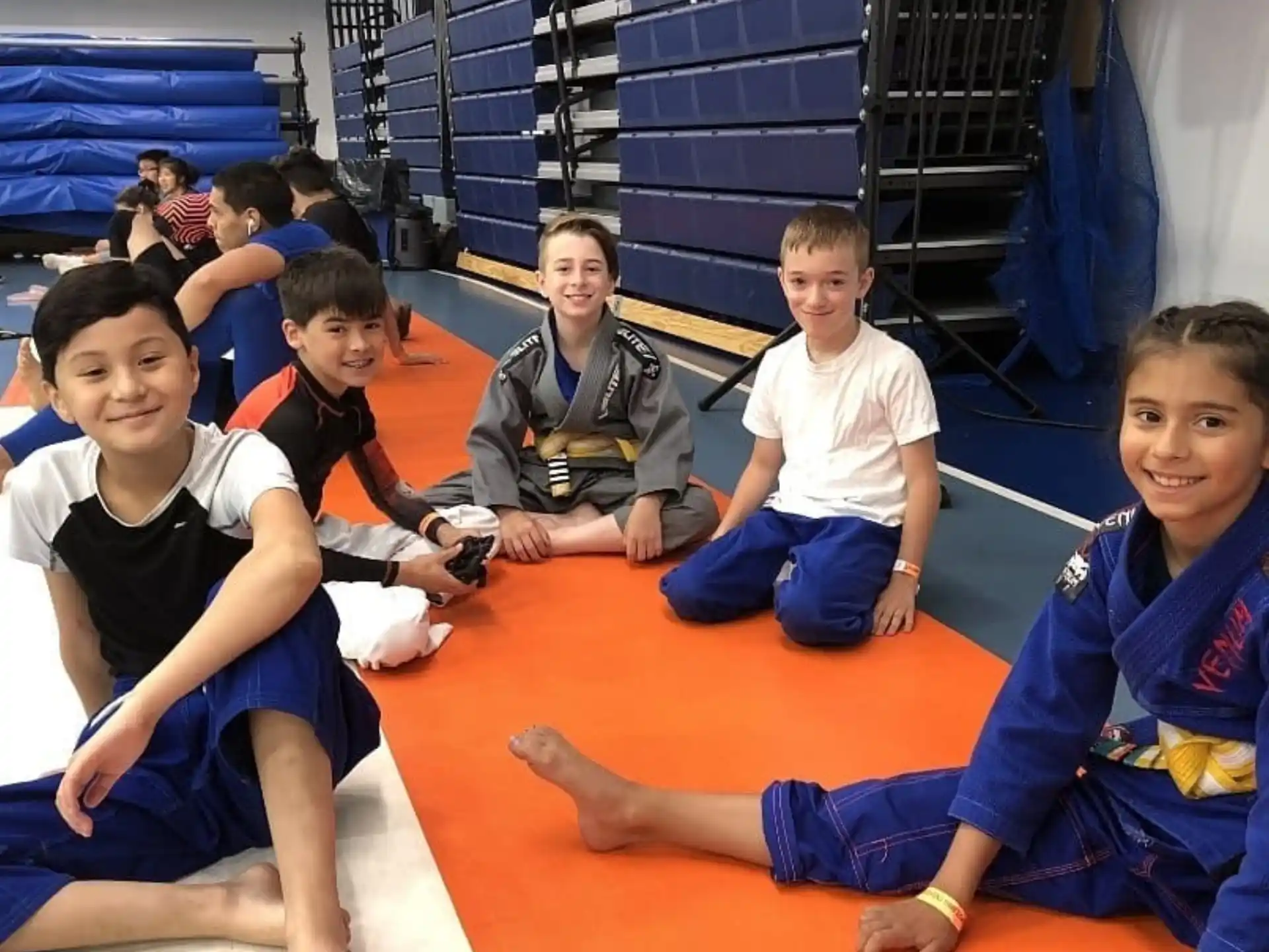 a group of young boys sitting on the floor