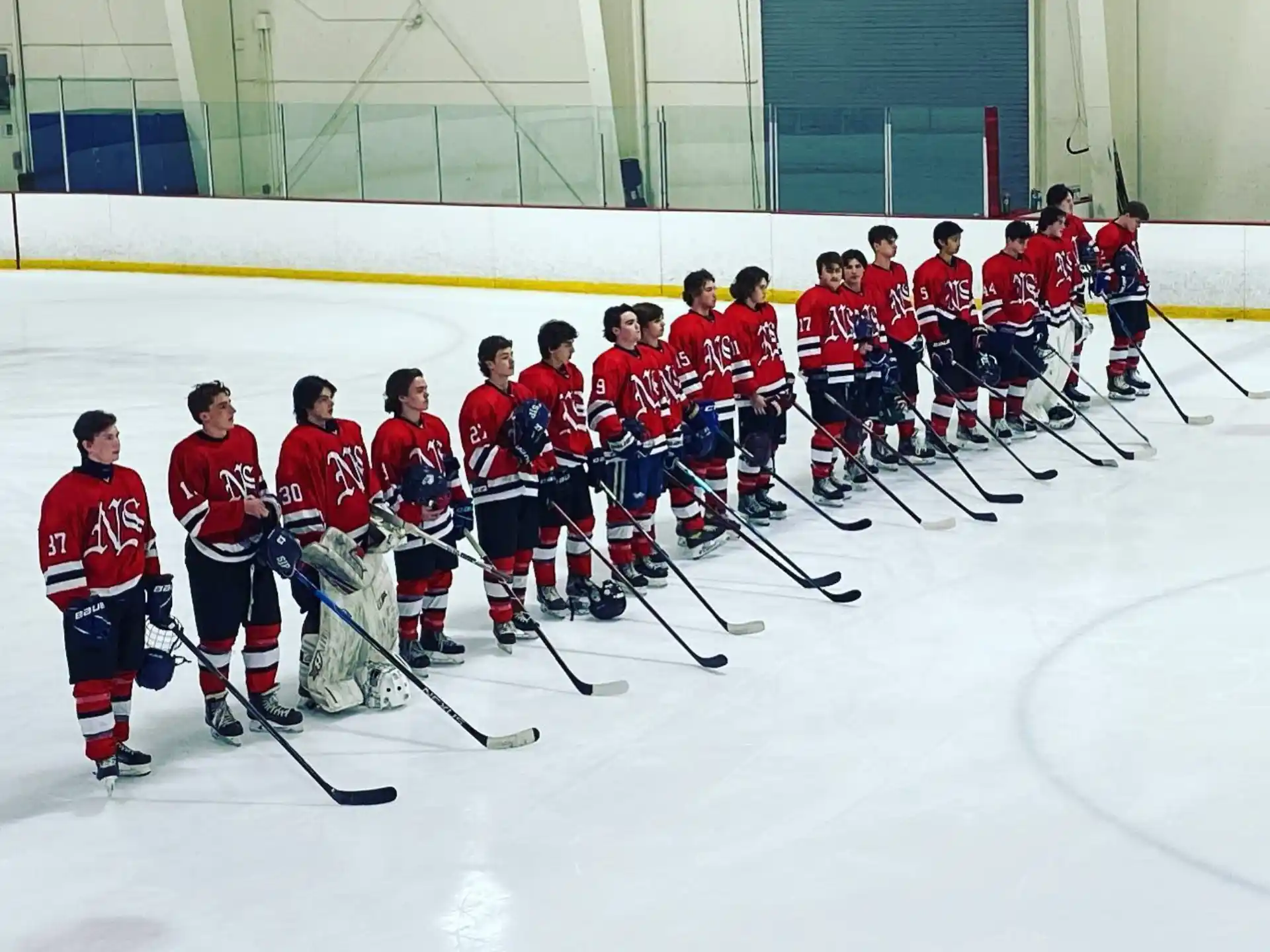 a group of hockey players posing for a photo