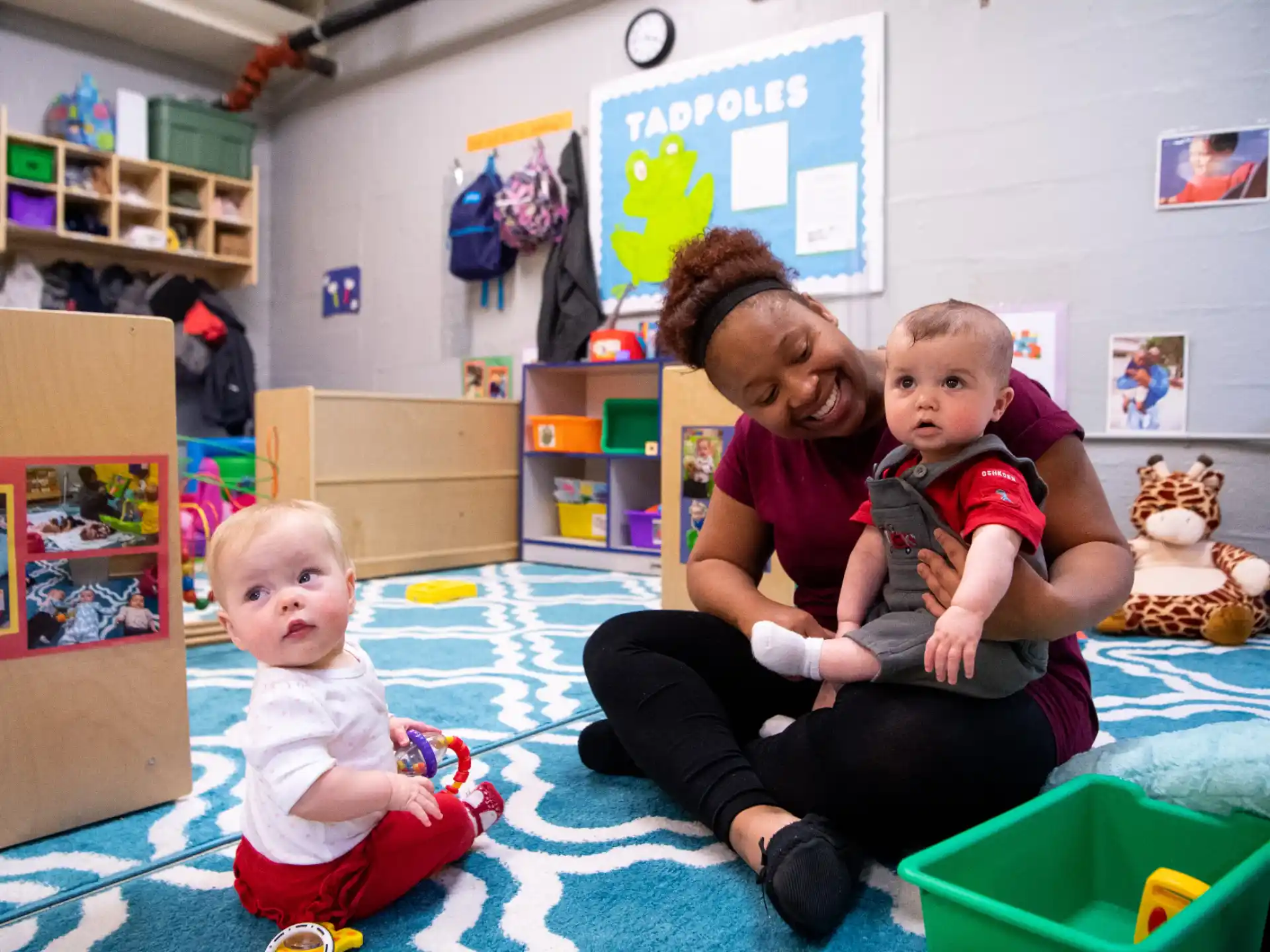 a person and two children sitting on the floor