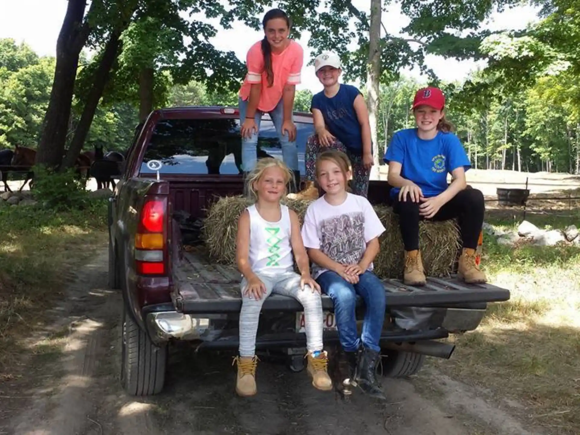 a group of people sitting on the back of a car