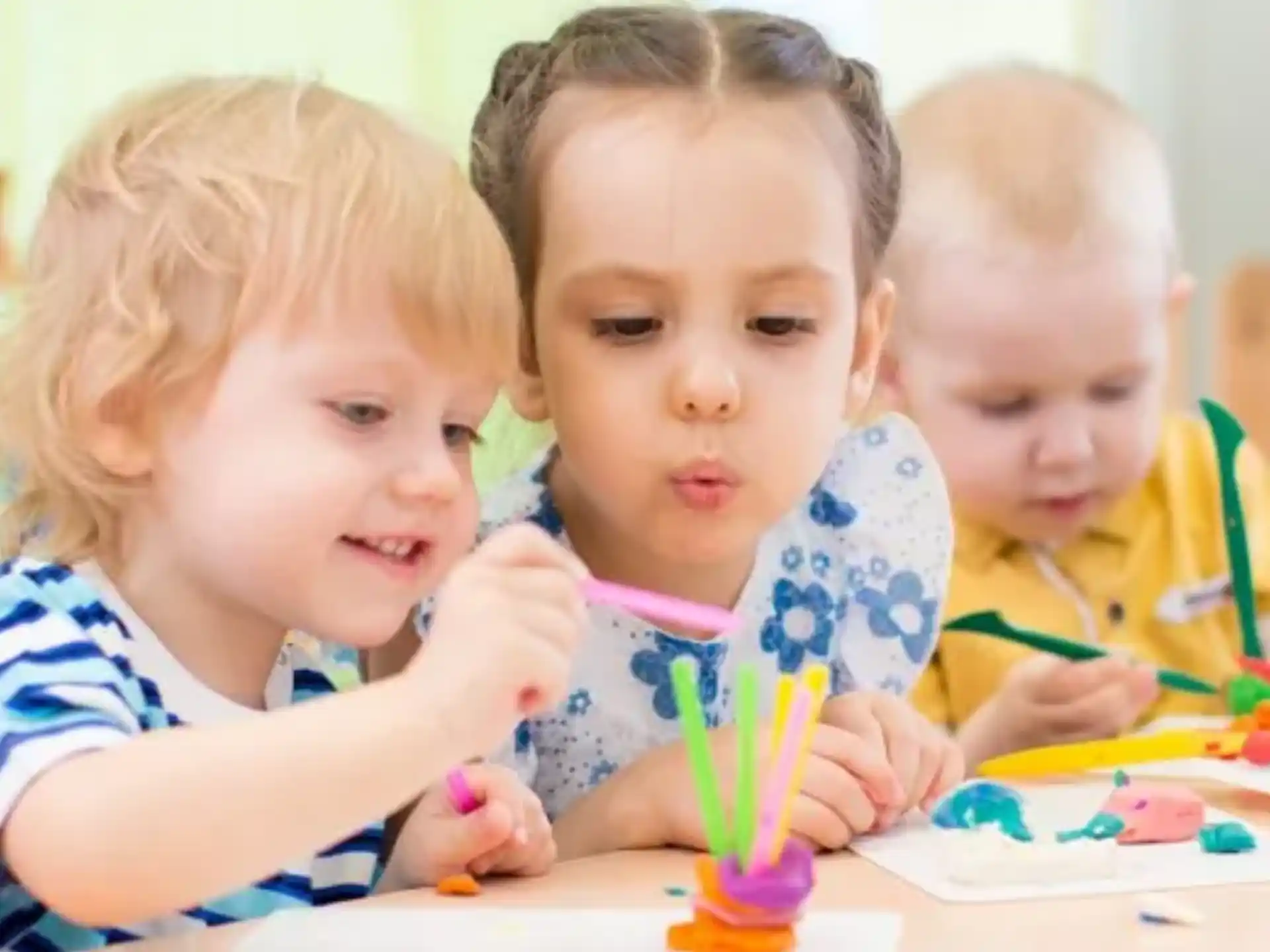 a group of children sitting at a table