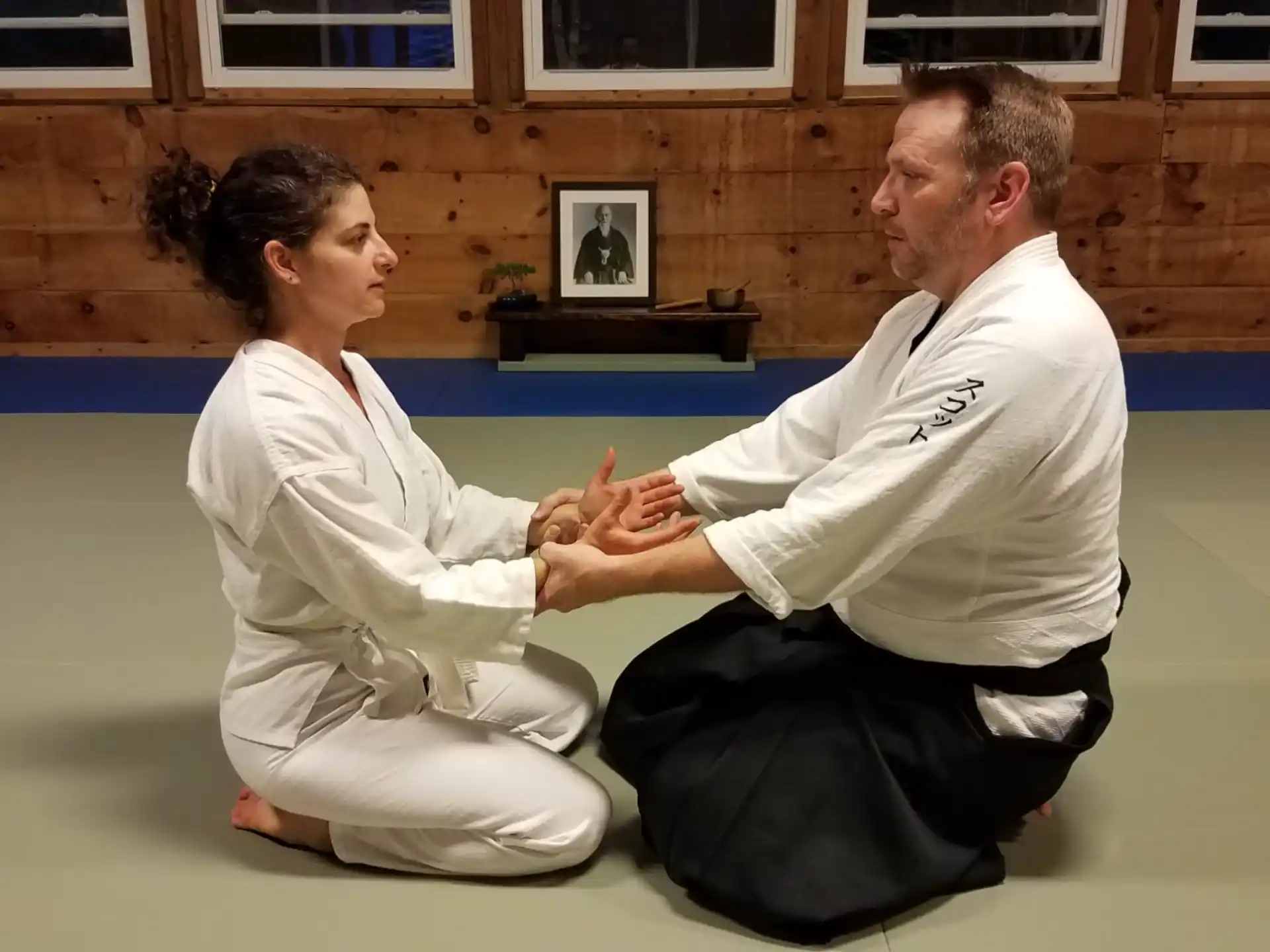 a man and a woman in karate uniforms sitting on the floor