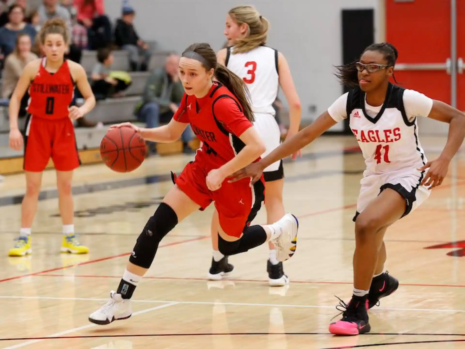 a group of women playing basketball