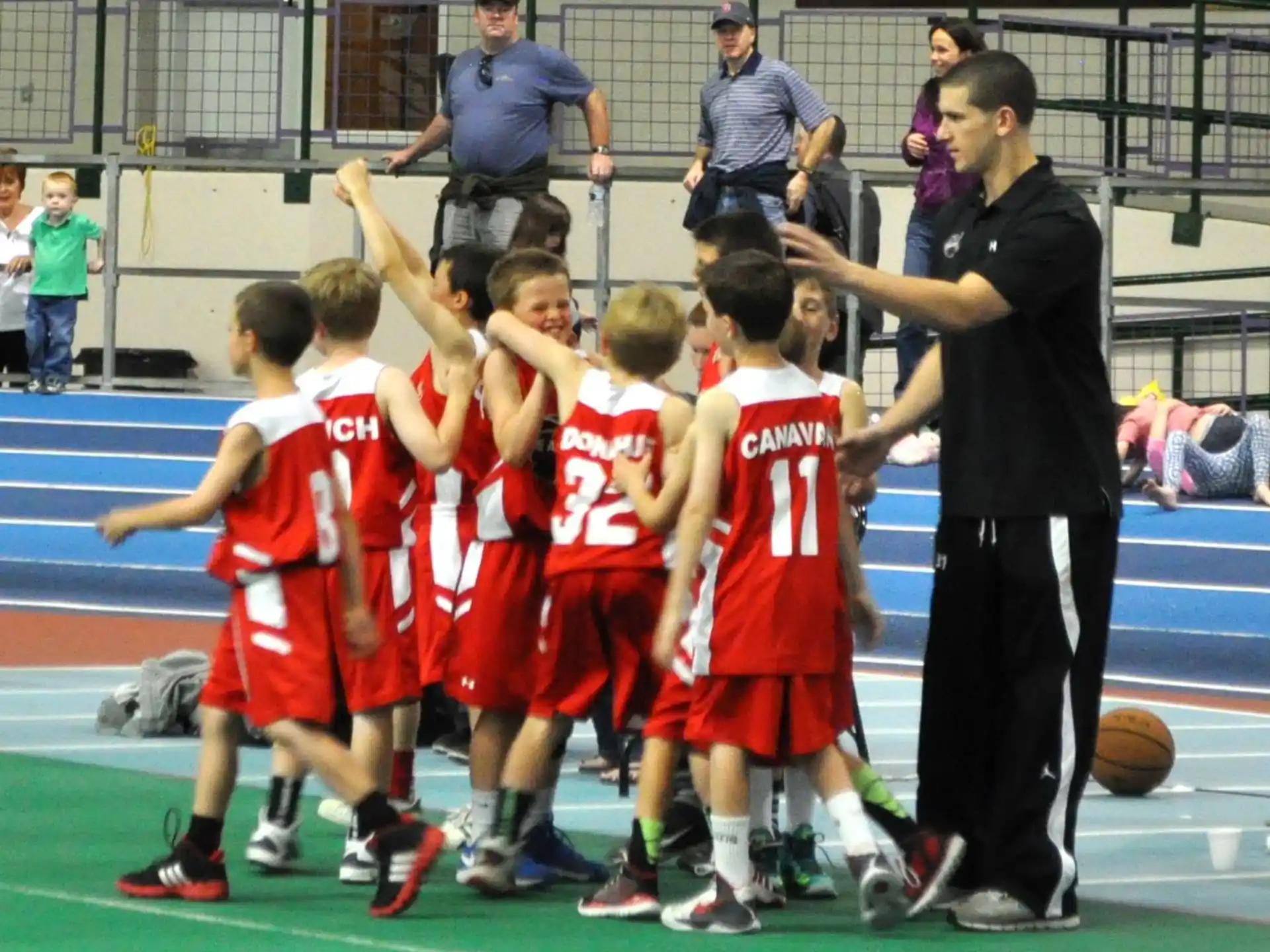 a group of kids playing basketball