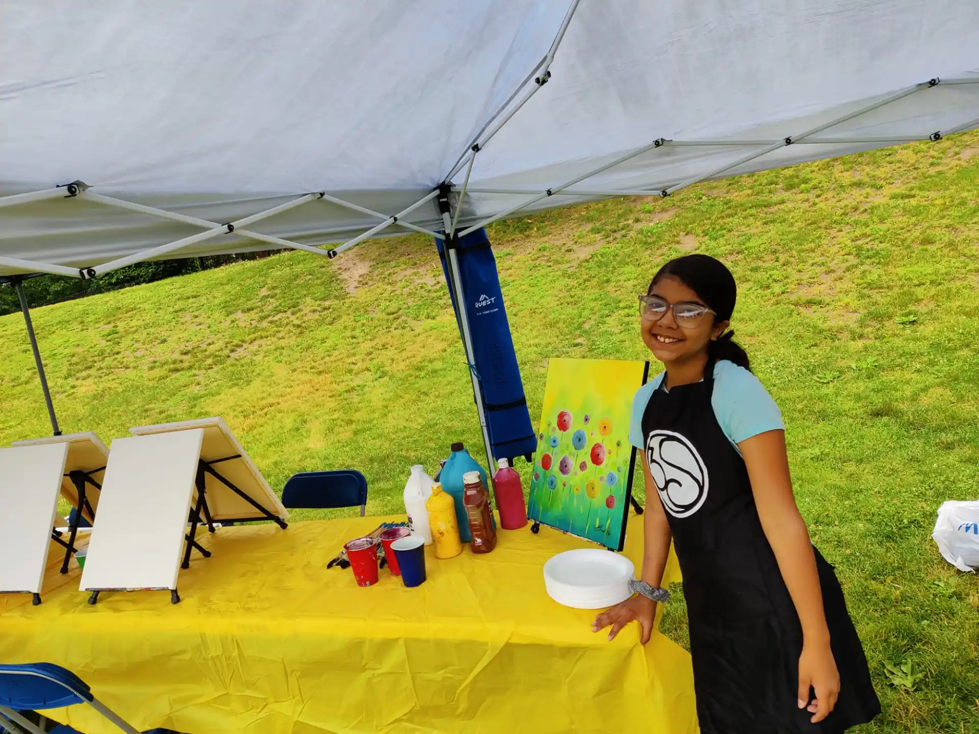 a person standing next to a table with food and drinks on it