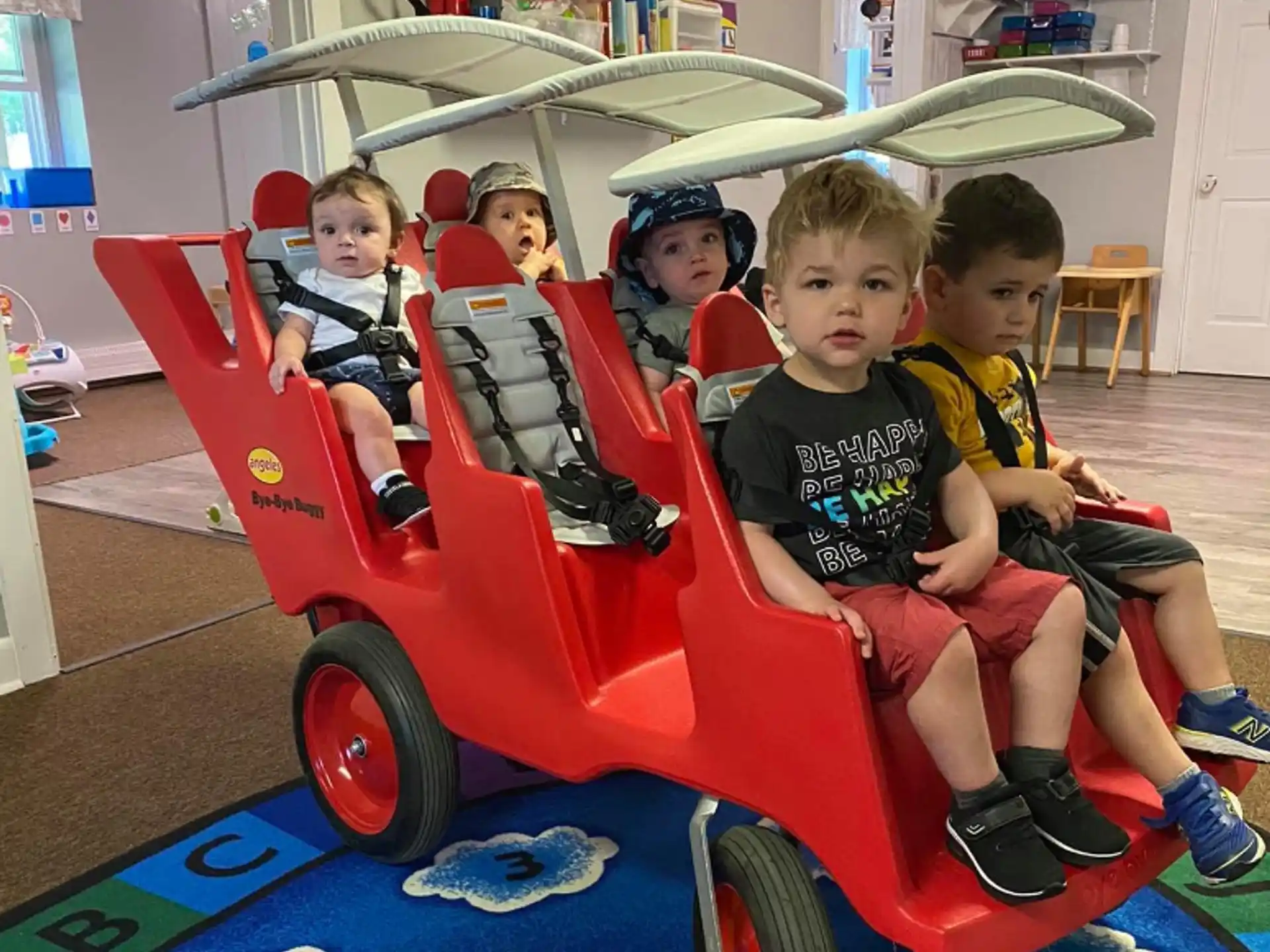 a group of kids sitting in a toy car