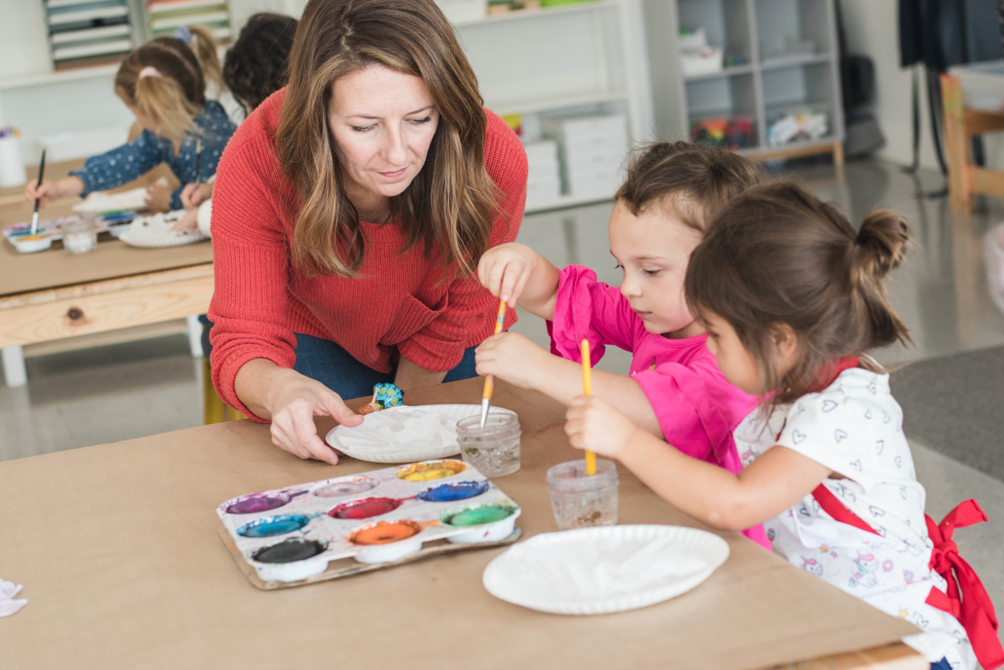 a person and a child painting