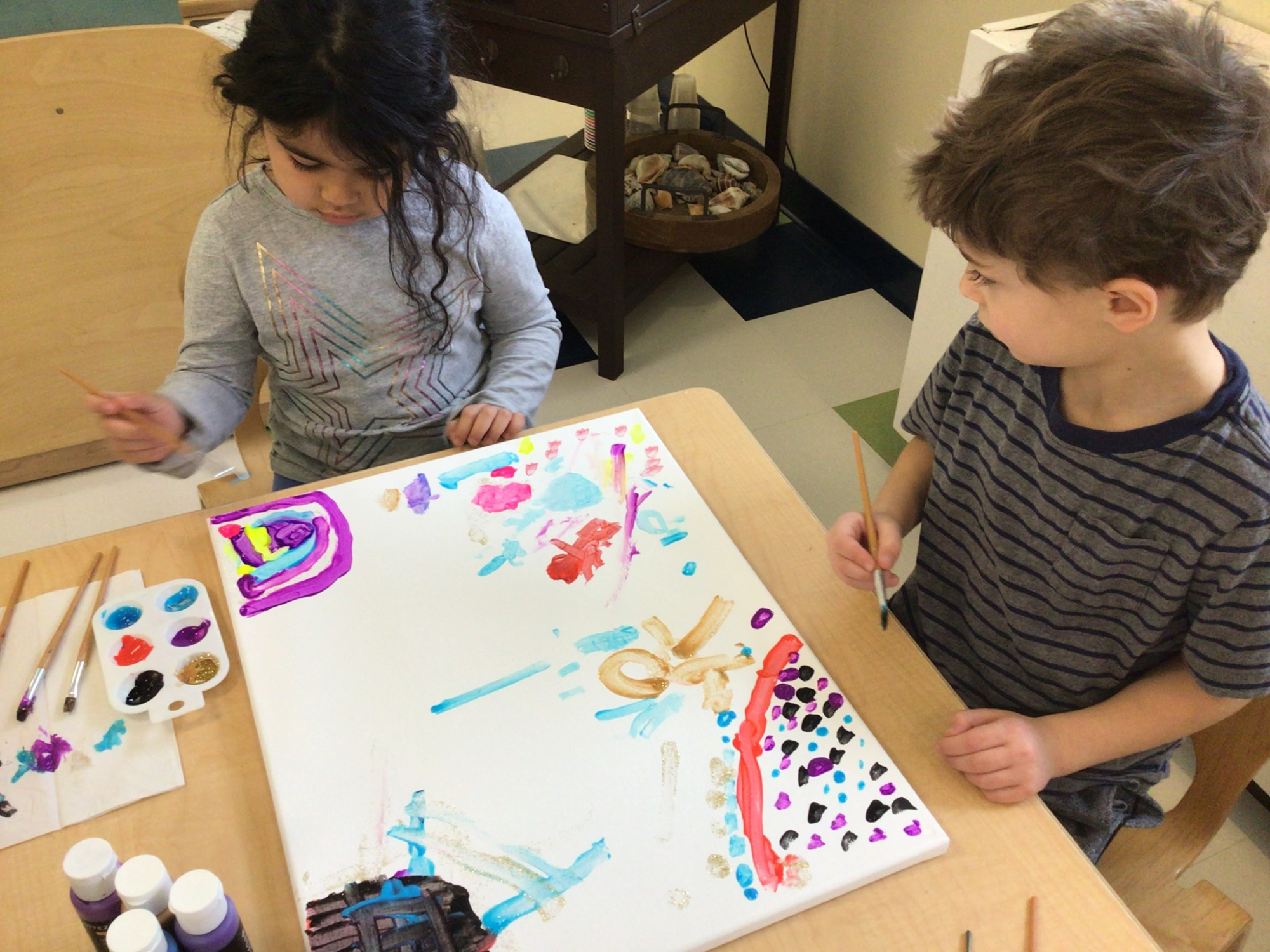 a few children playing with a puzzle