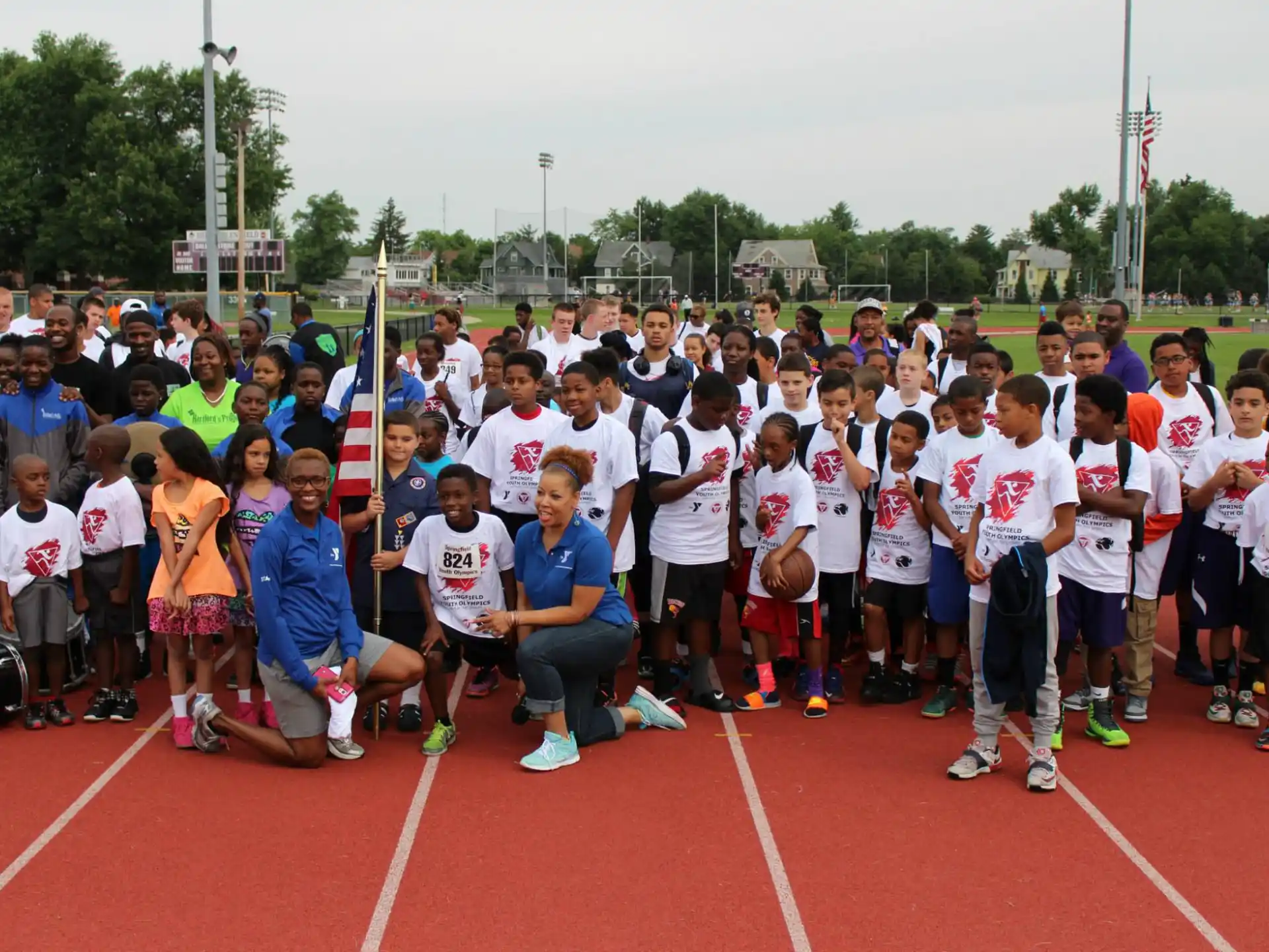 a group of people posing for a photo on a track