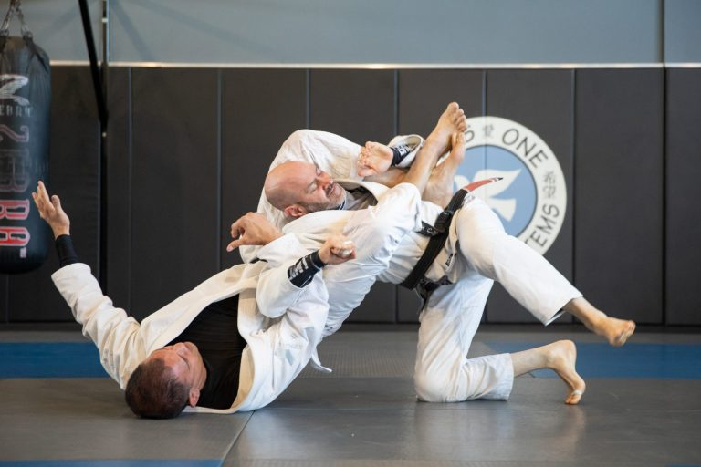 a person kicking another man in the face