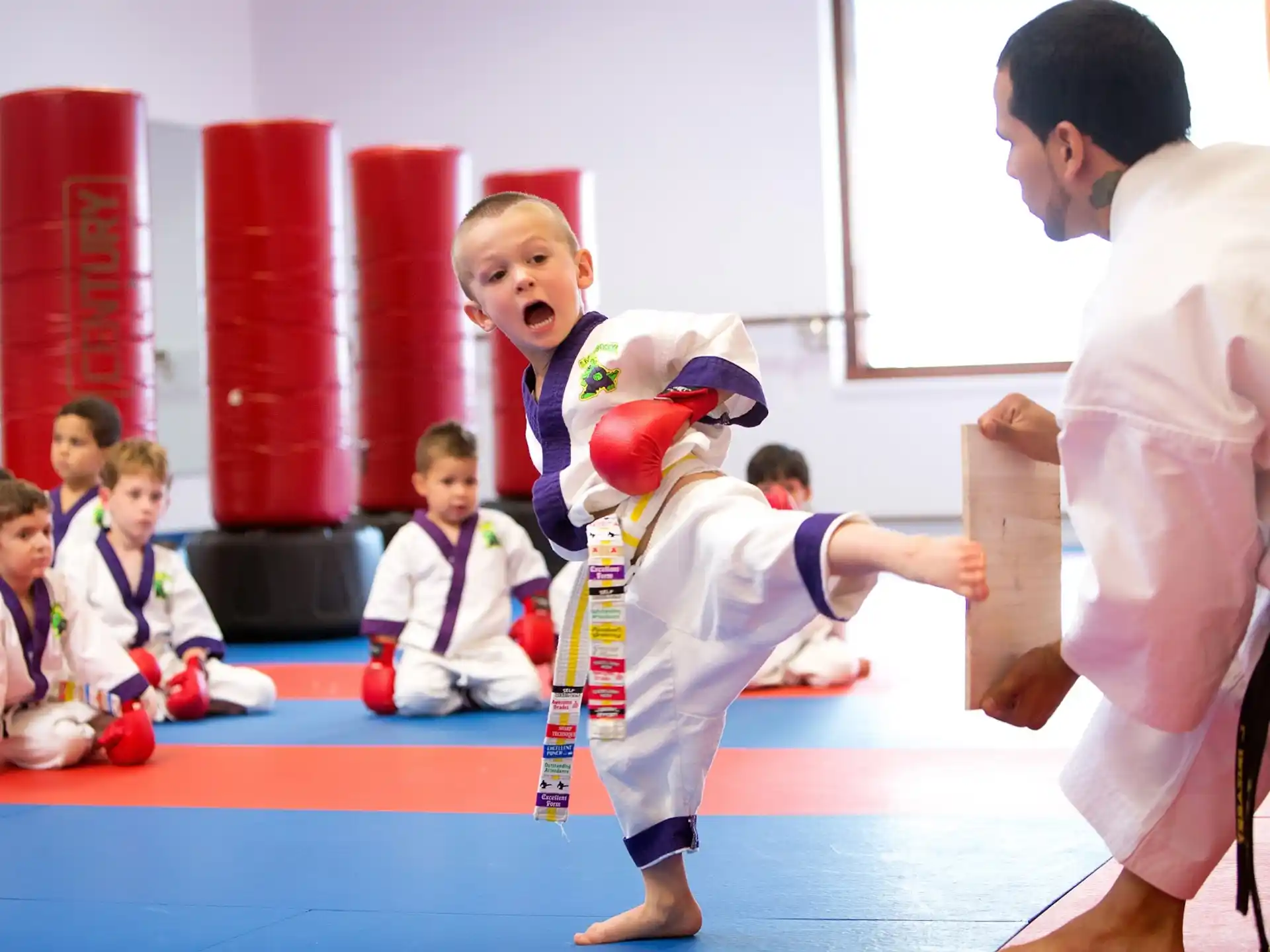 a group of kids in karate uniforms