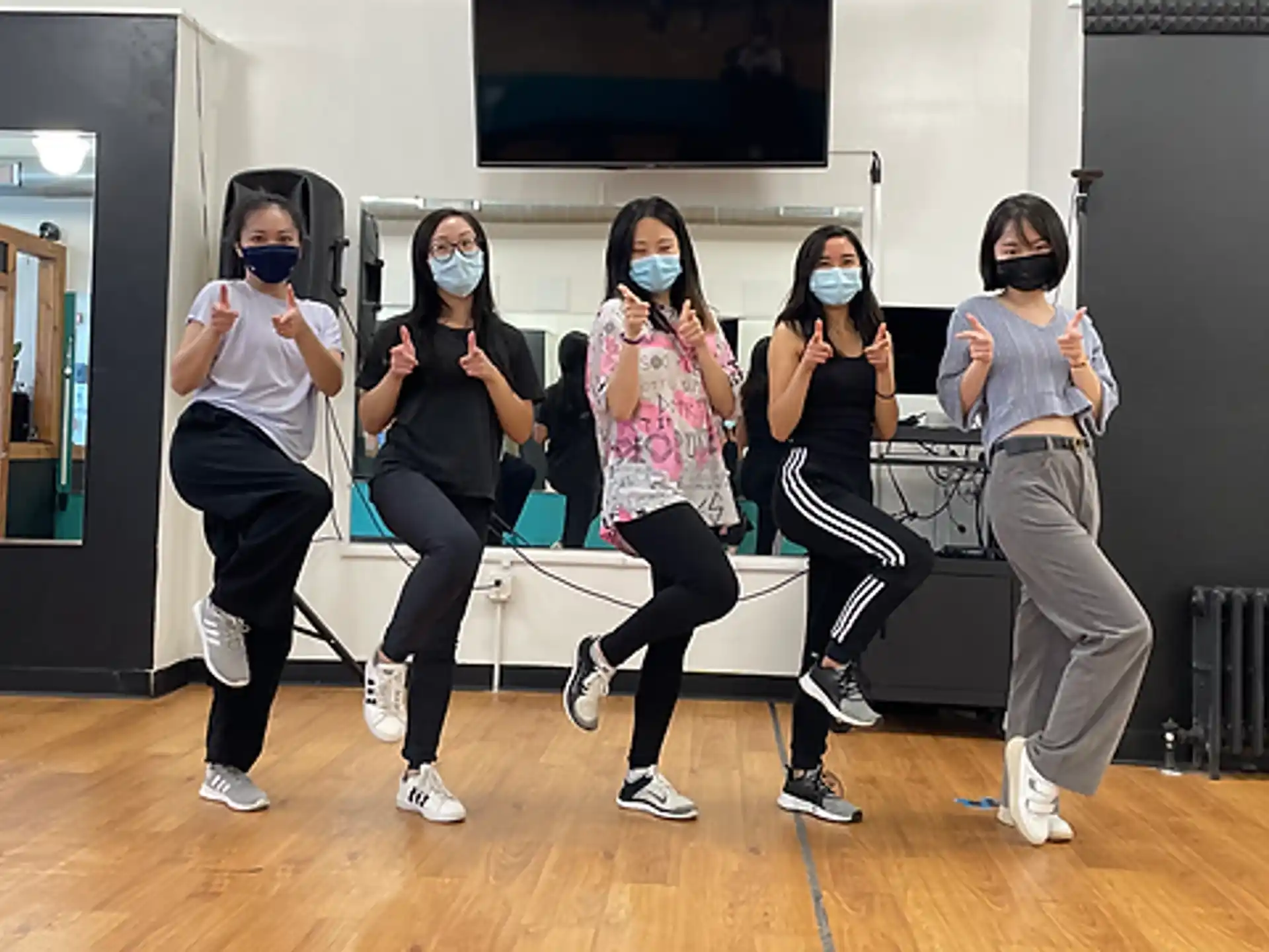a group of women wearing masks