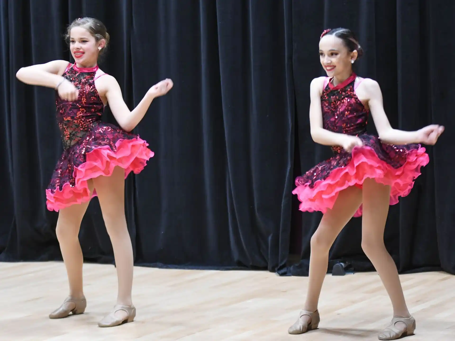 two women wearing dresses and dancing