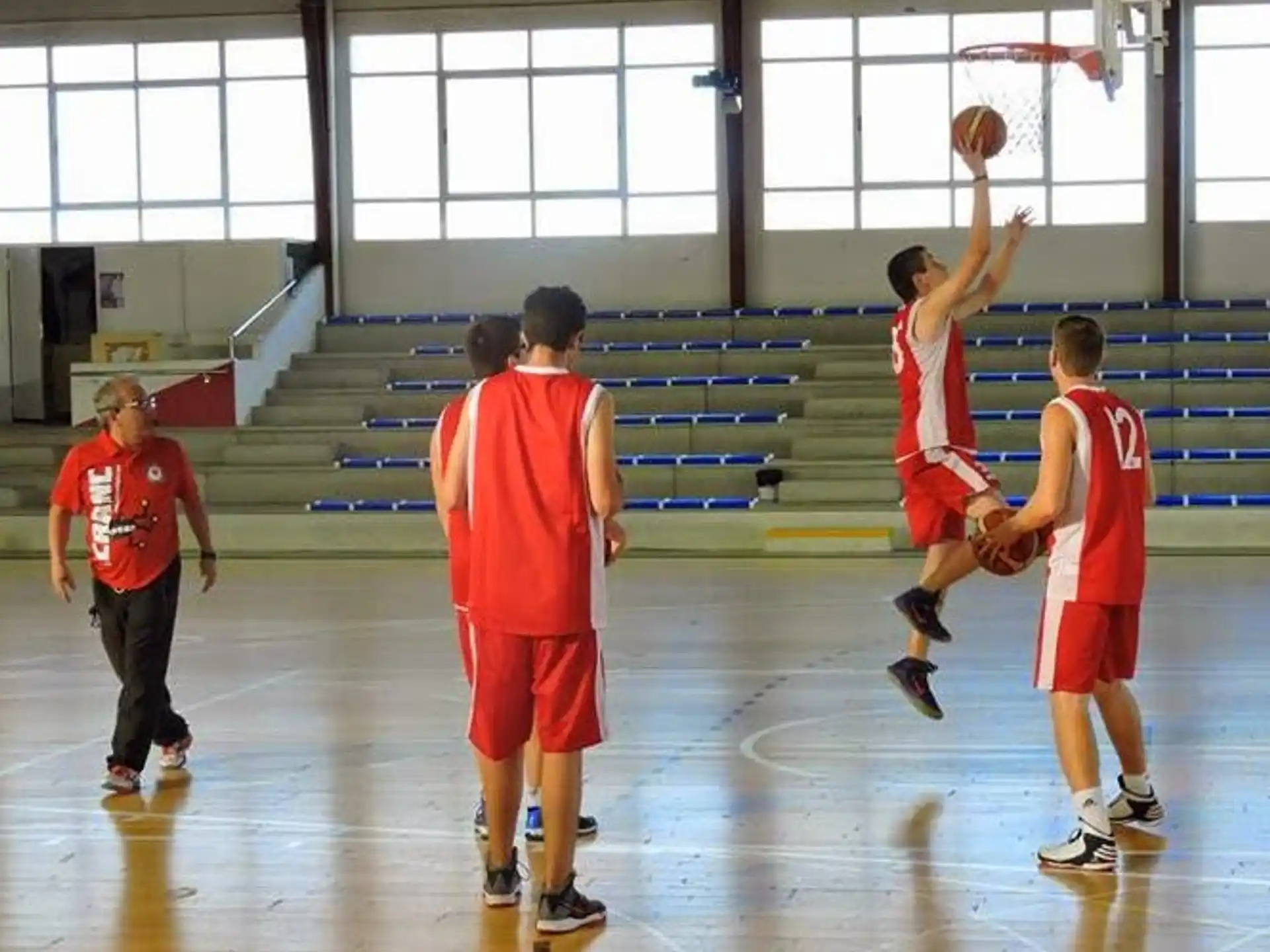 a group of people playing basketball